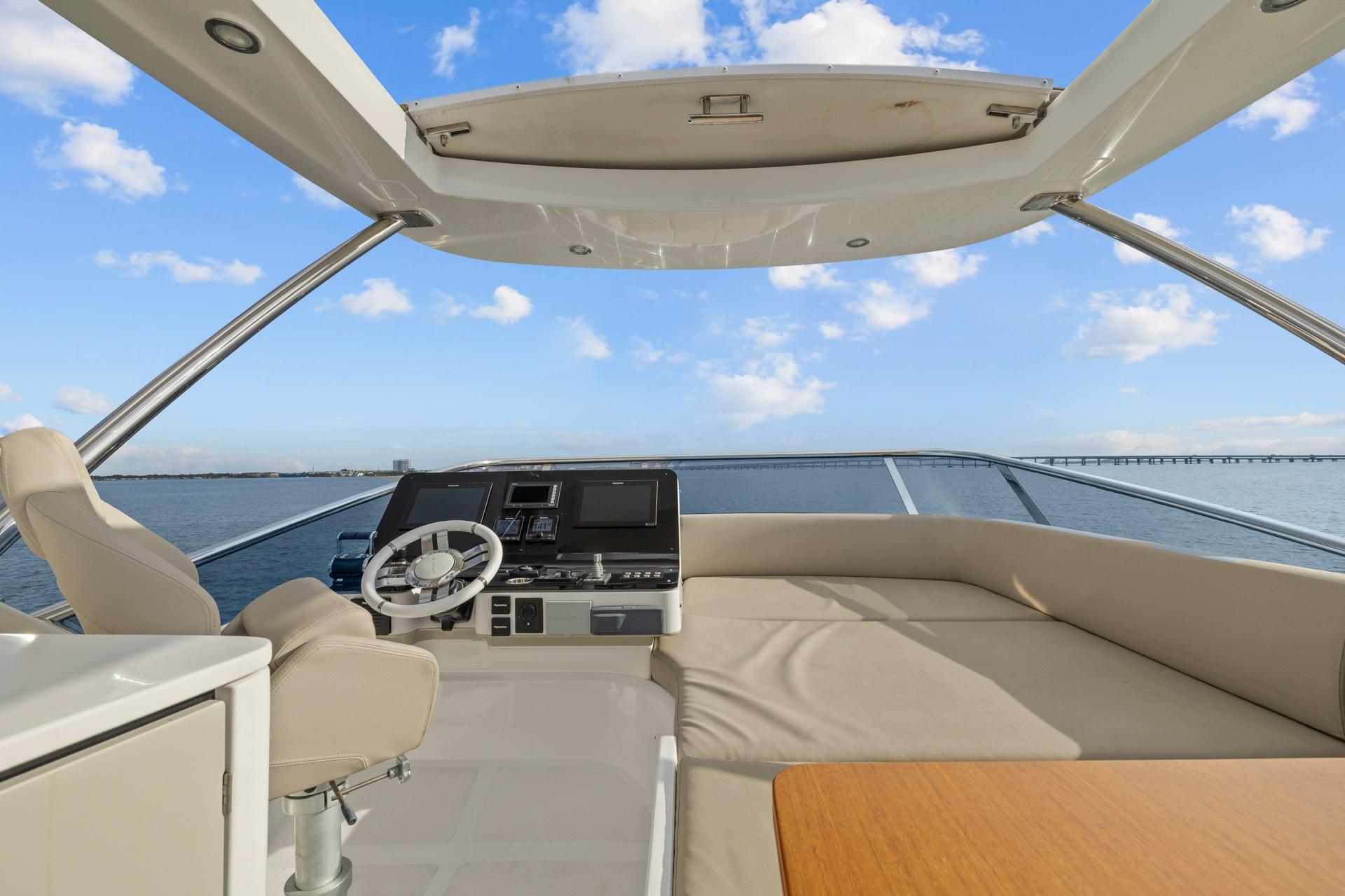 Flybridge of 2019 Azimut 55 yacht with helm, seating, and ocean view.