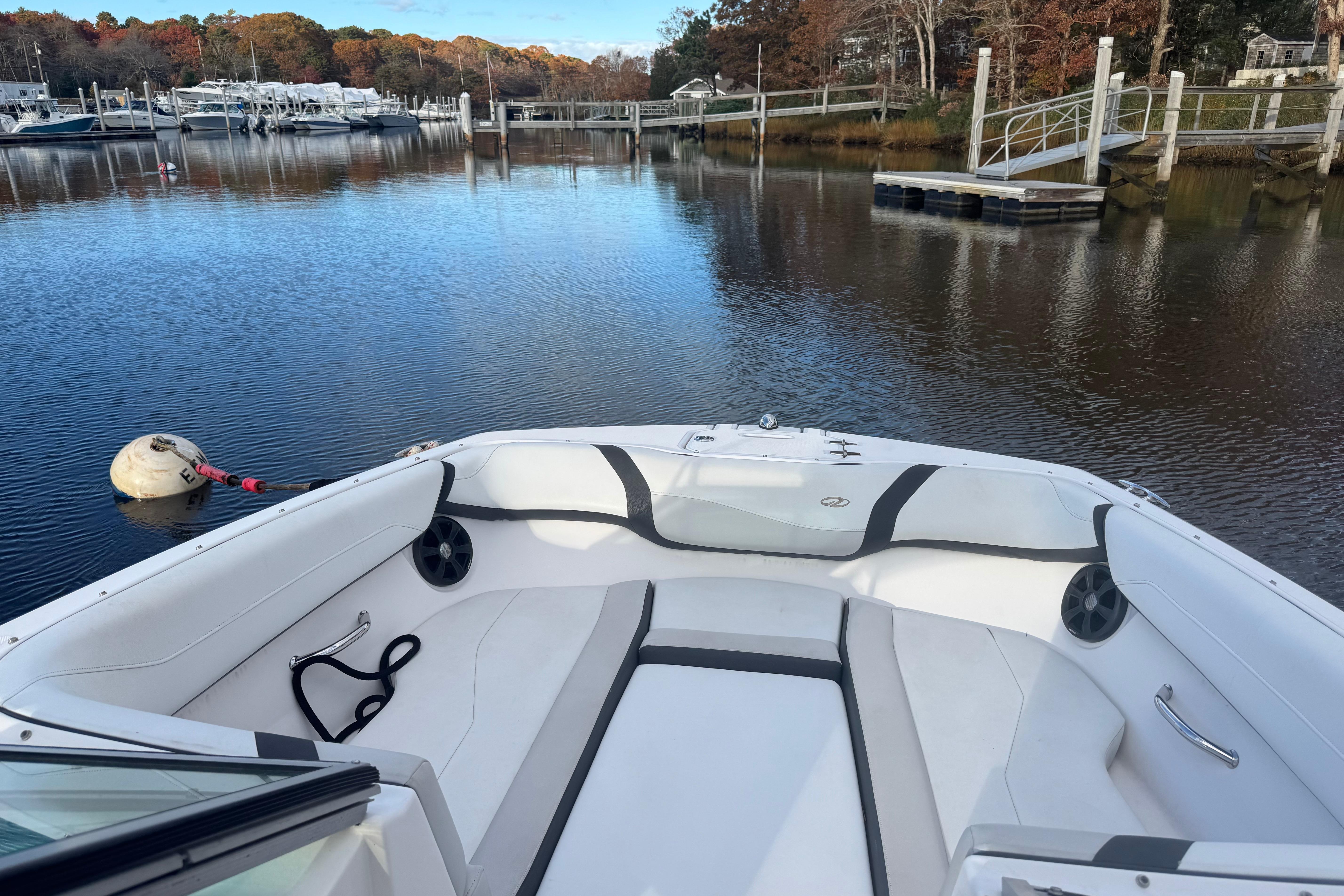 2017 Regal 23 OBX boat interior on calm water near a dock.