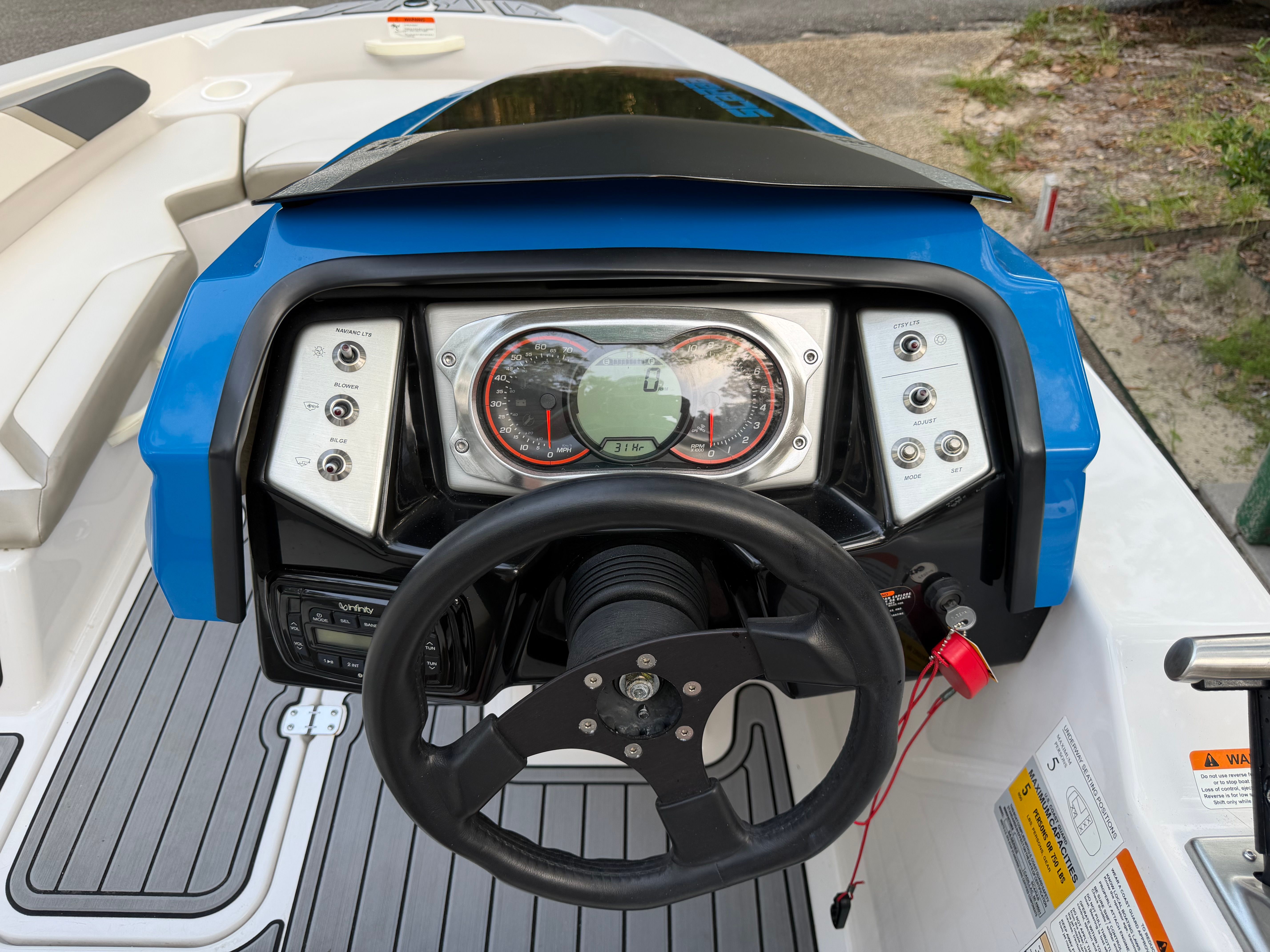 Dashboard of a 2015 Scarab 165 with blue casing and black steering wheel.