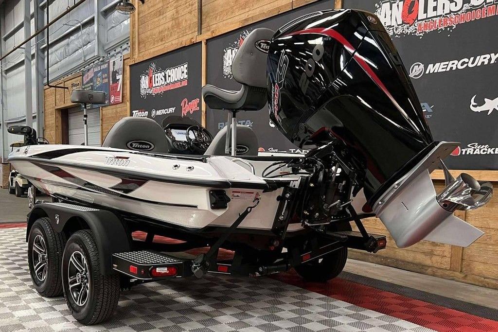 2026 Triton 18 TrX boat with powerful outboard motor in showroom setting.