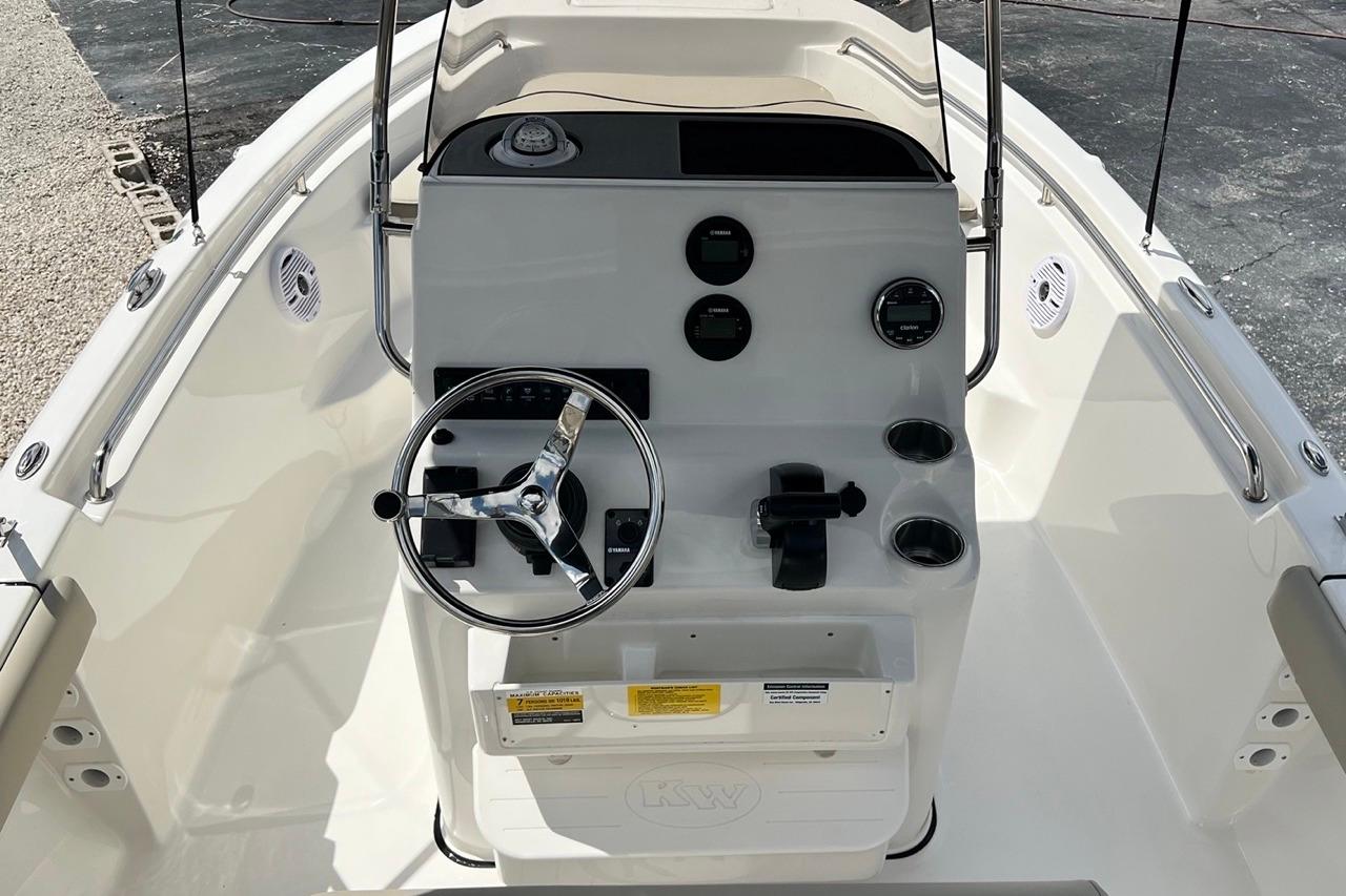 2026 Key West 189 FS boat console with steering wheel and gauges, featuring a sleek design.