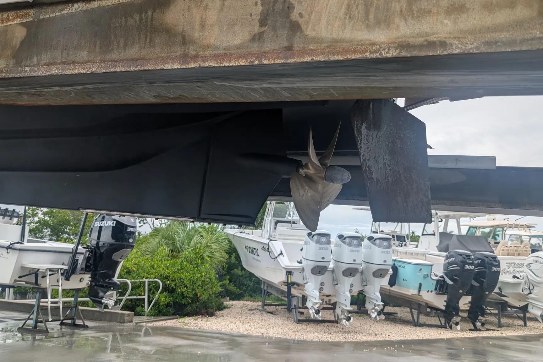 2015 Ranger Tugs R-29 S propeller and hull under a dock, with boats in background.