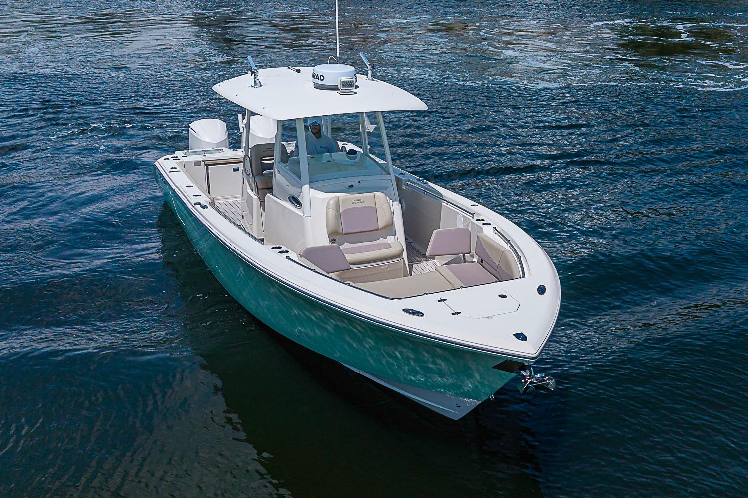 2019 Cobia 320 Center Console boat cruising on open water.