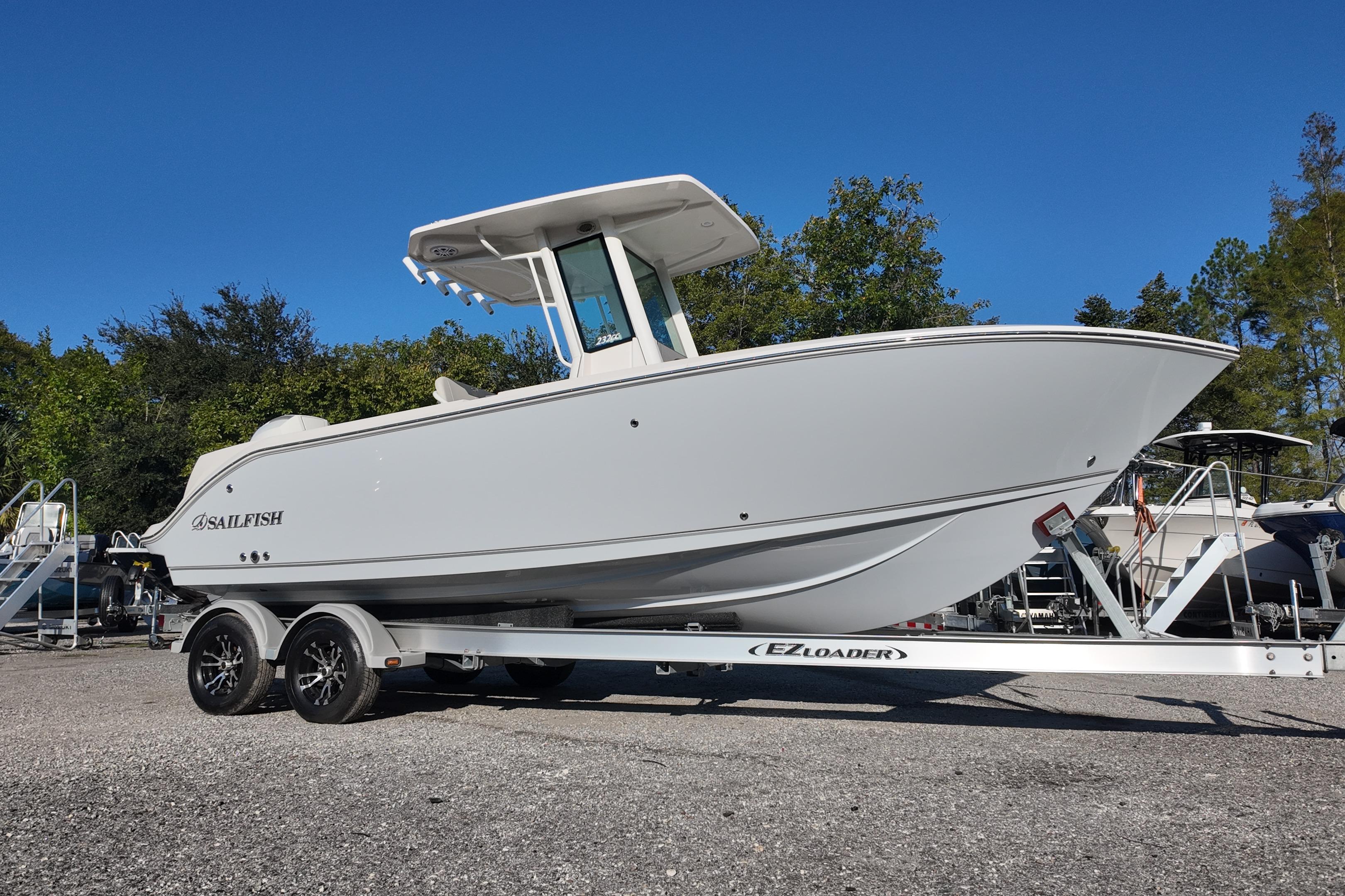 2026 Sailfish 232 CC boat on EZ Loader trailer, parked outdoors.