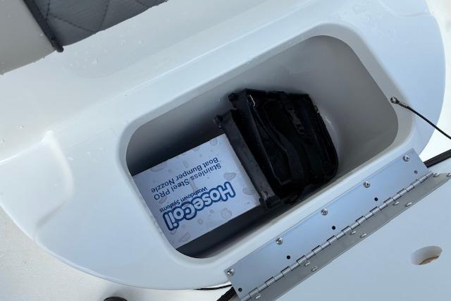 Storage compartment in Key West 189 FS boat with accessories.