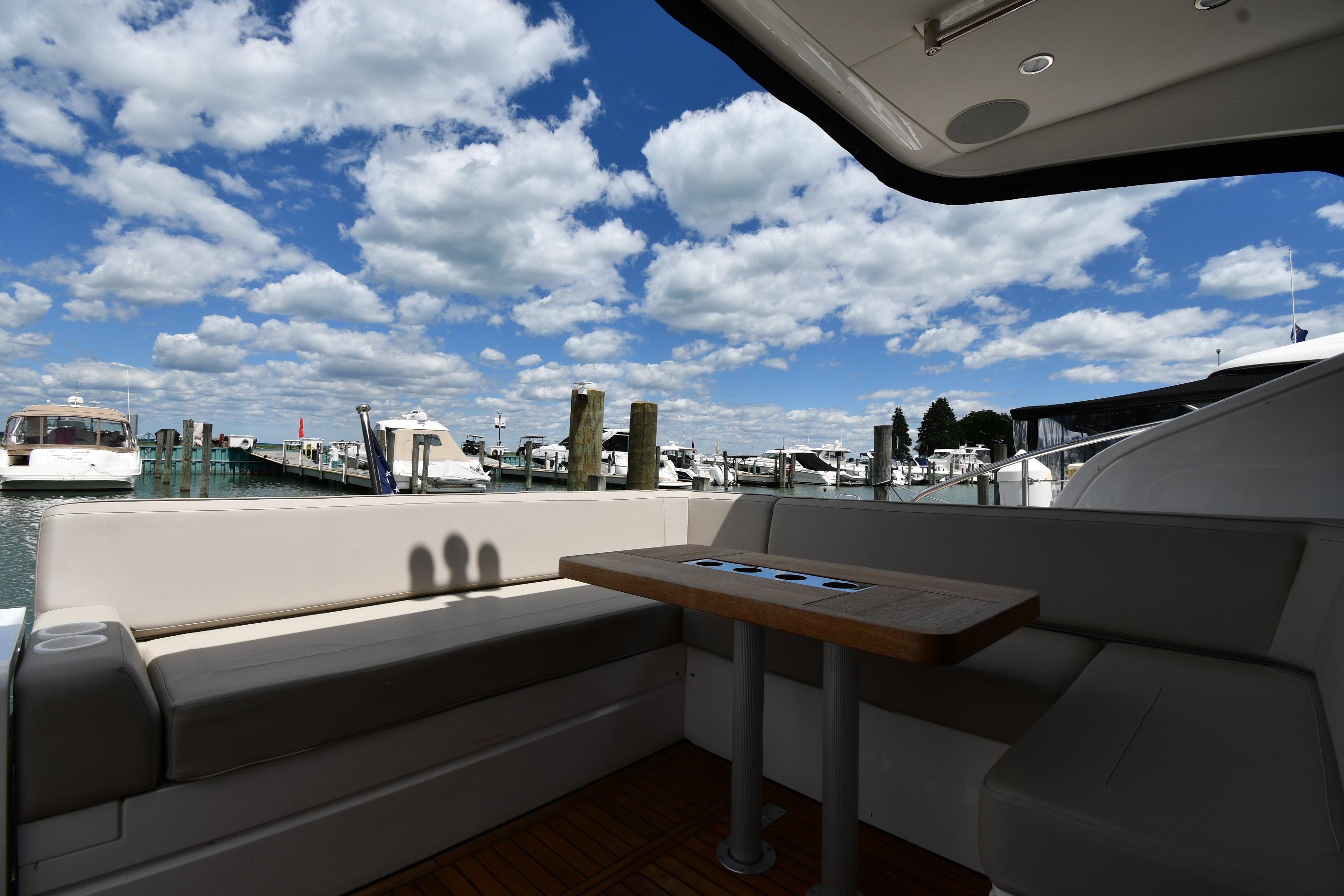 2024 Fairline G50 Targa yacht interior with marina view under blue sky.