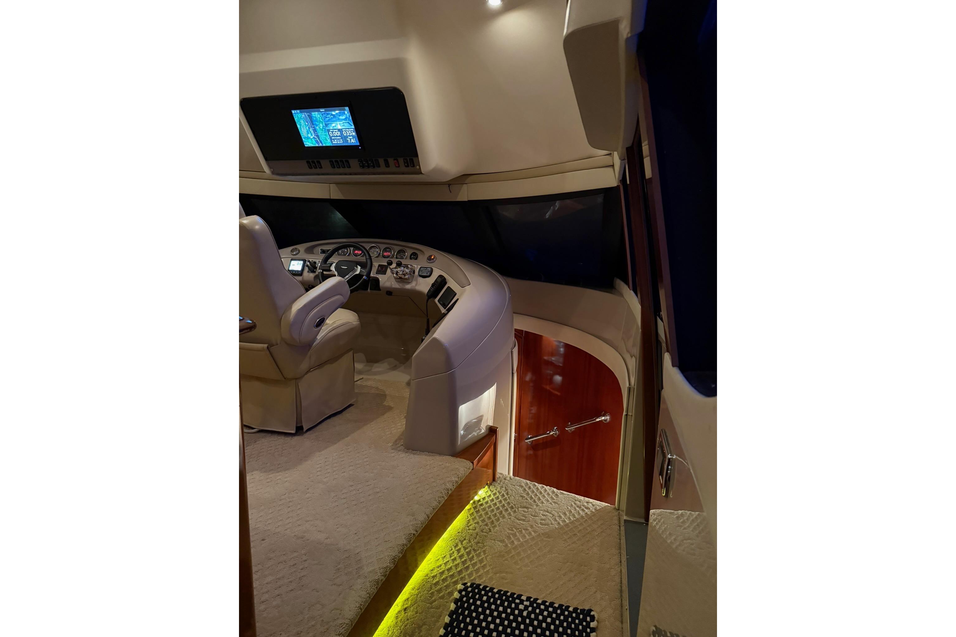 2006 Carver 56 Voyager yacht helm with modern controls and luxurious interior design.