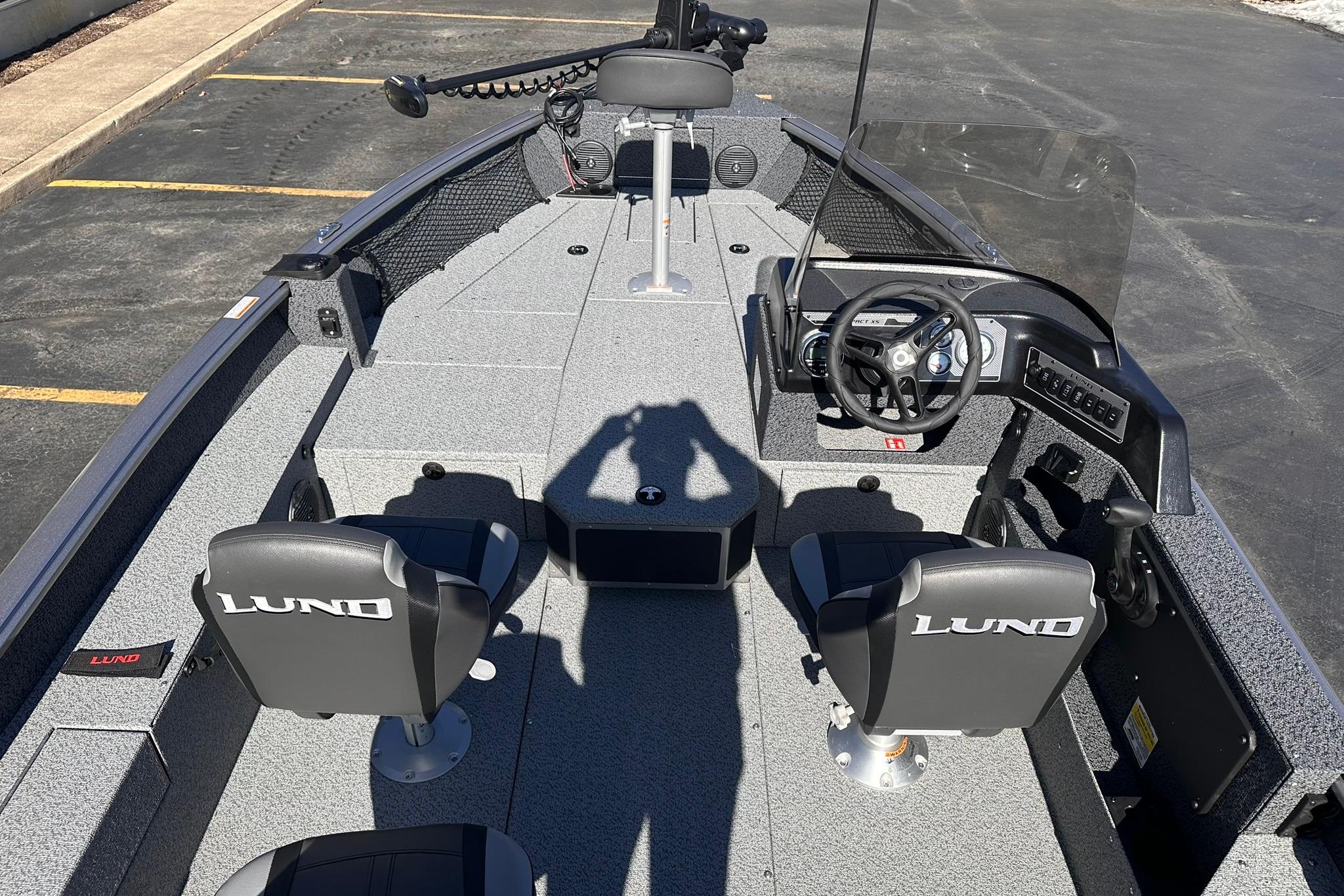 2026 Lund 1875 Impact XS SS boat interior with steering console and seating.