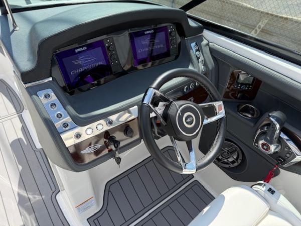 2023 Chaparral 267 SSX boat dashboard with dual Simrad displays and sleek steering wheel.