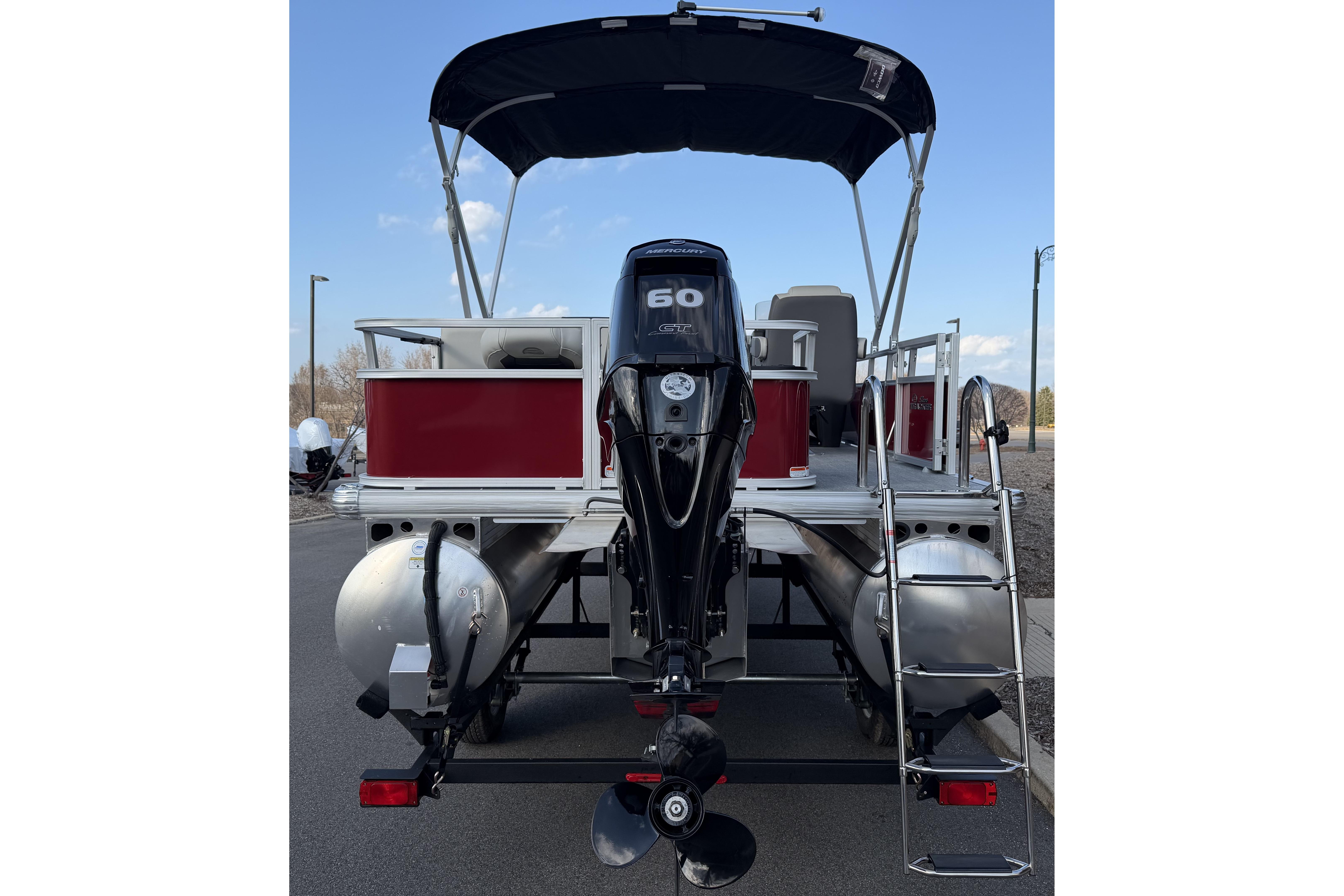 2026 Sun Tracker Bass Buggy 18 DLX pontoon boat, rear view with motor and ladder.