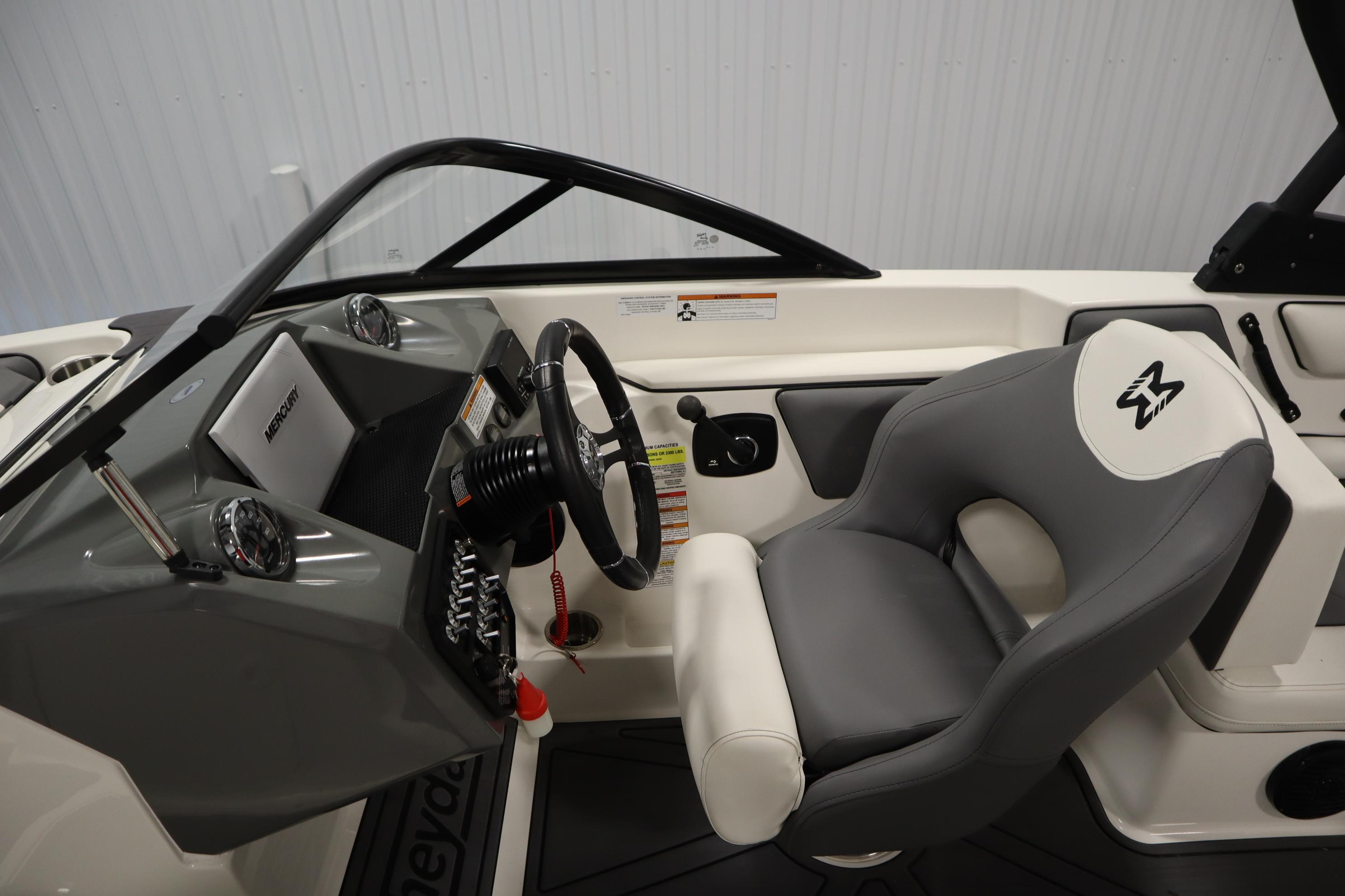 2023 Heyday WT Surf boat interior with steering wheel and comfortable seating.