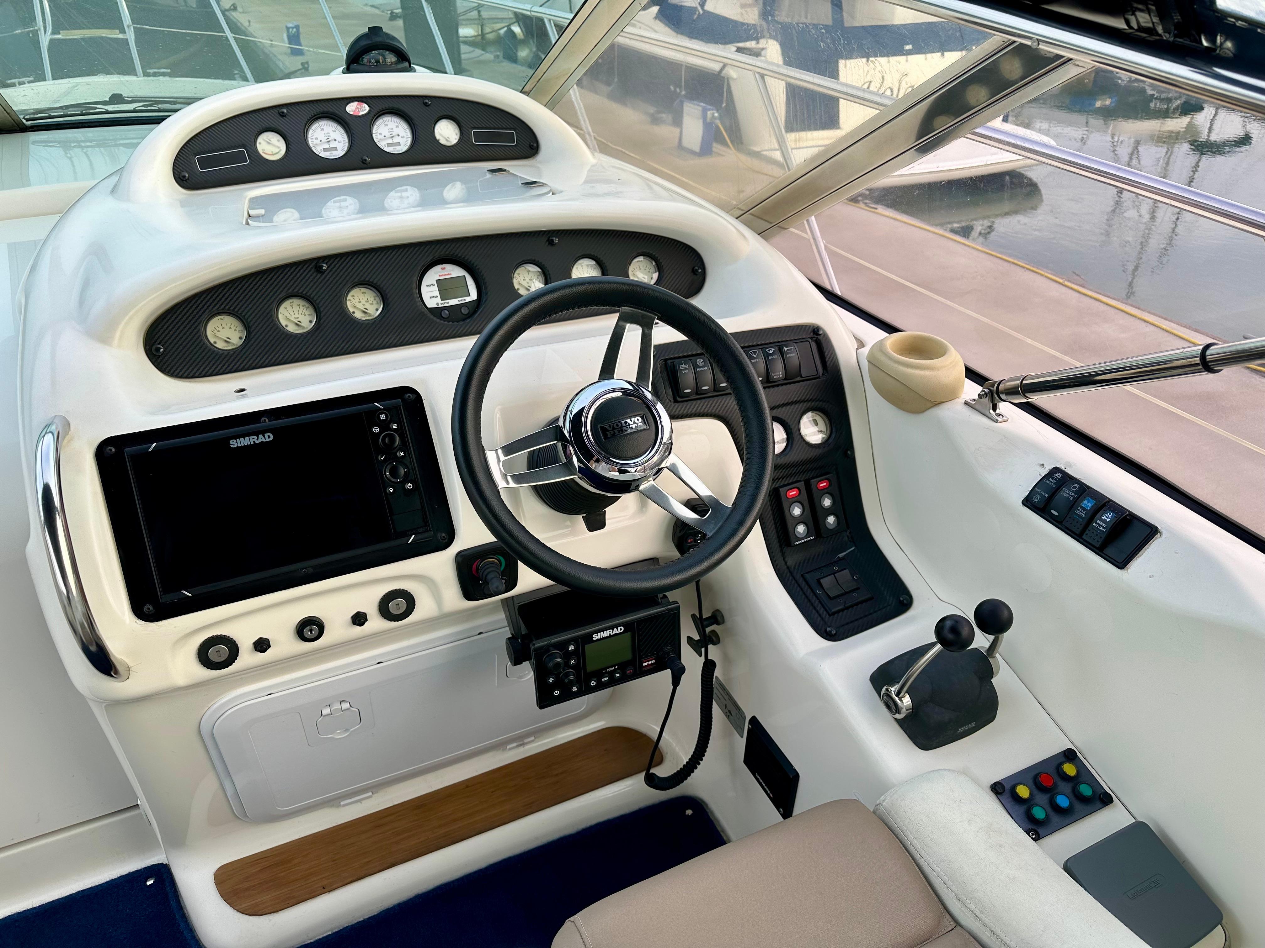 Cockpit of 1999 Cranchi Endurance 39 with steering wheel and control panel.