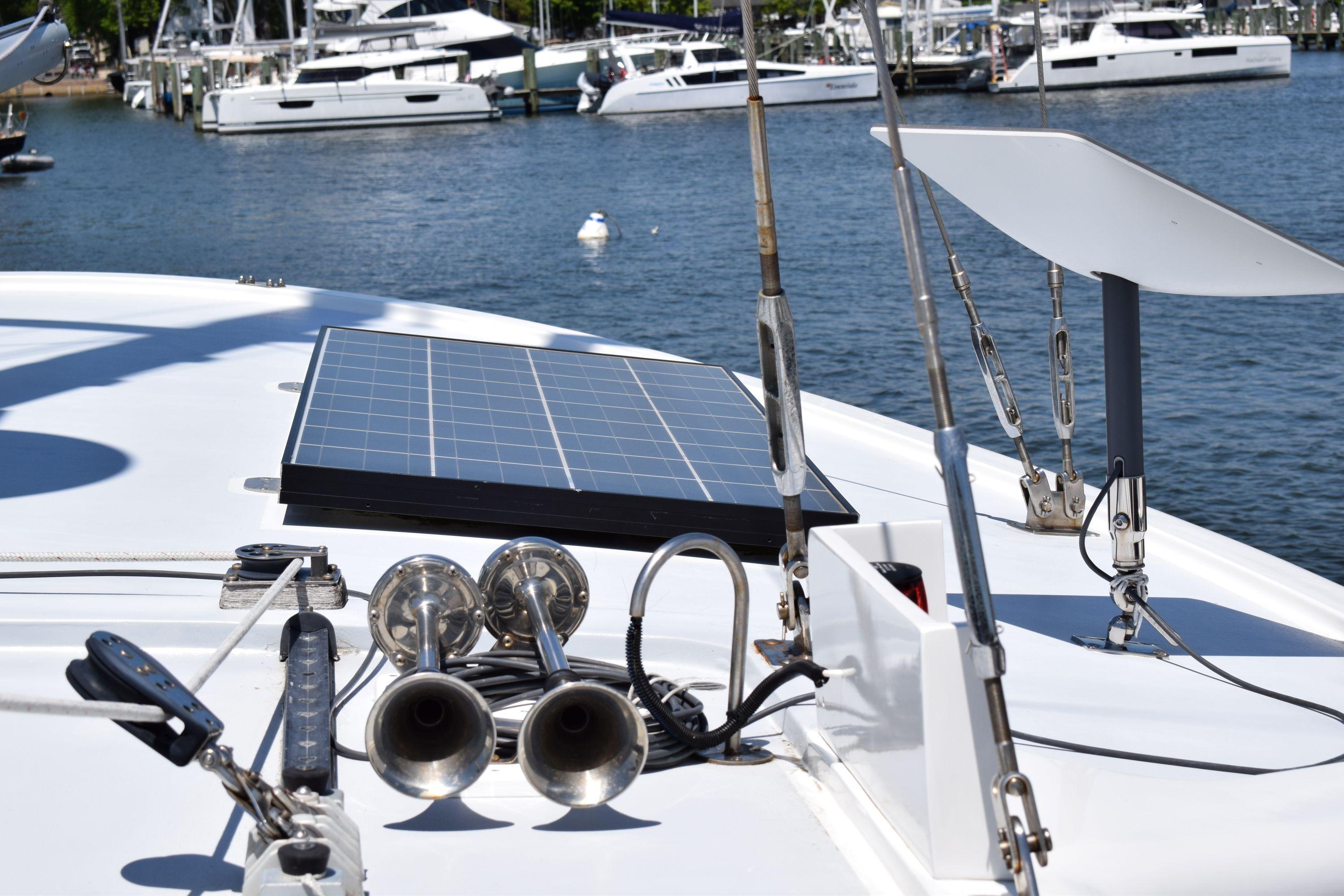 1980 Cheoy Lee 52 Motorsailer deck with solar panel and horns in marina.