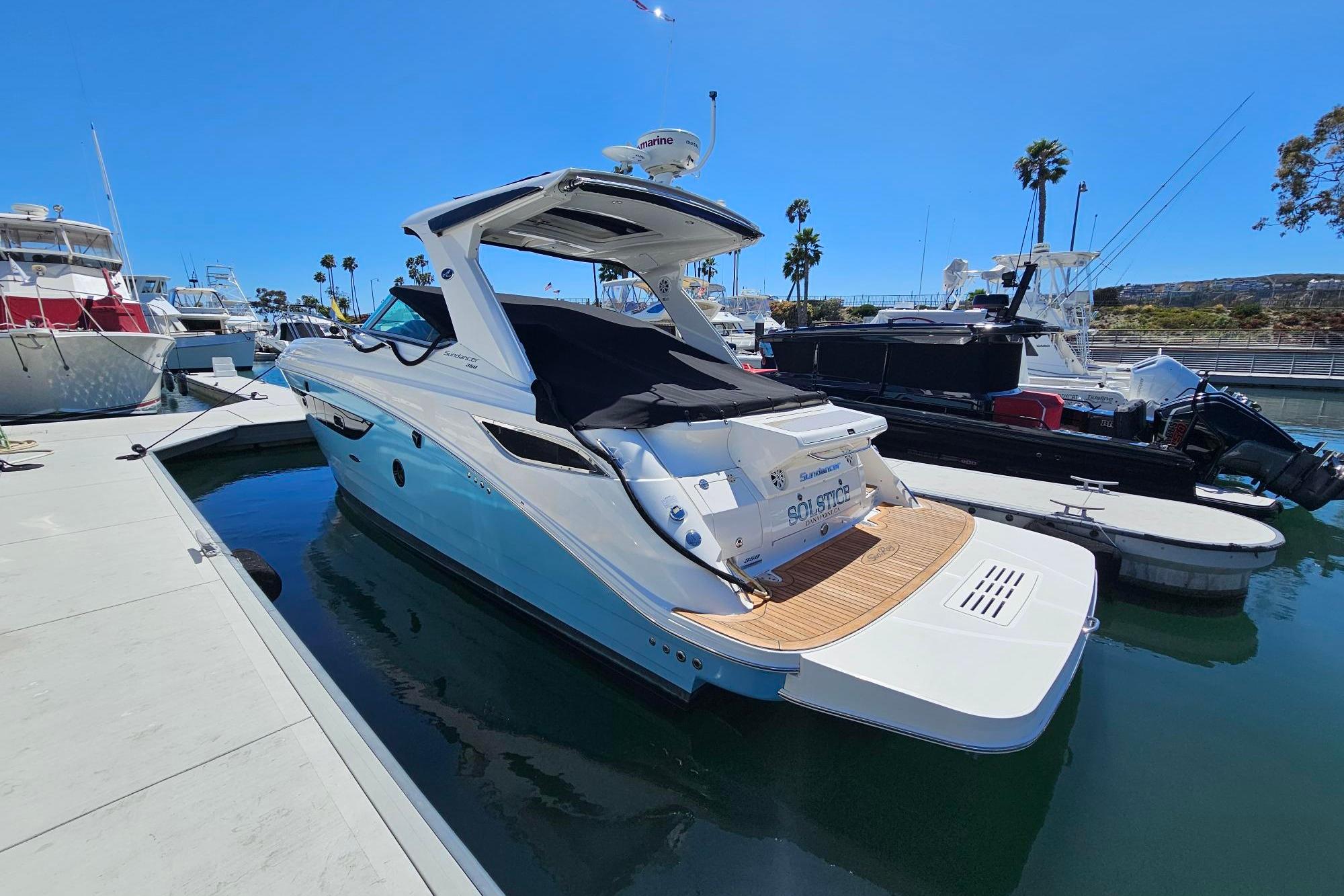 2016 Sea Ray Sundancer 350 yacht docked at marina under clear blue sky.