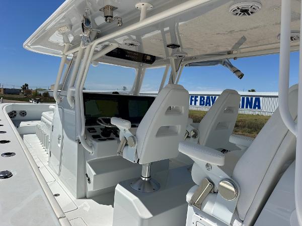 Freeman 42LR 2022 boat interior with modern helm and seating at marina.