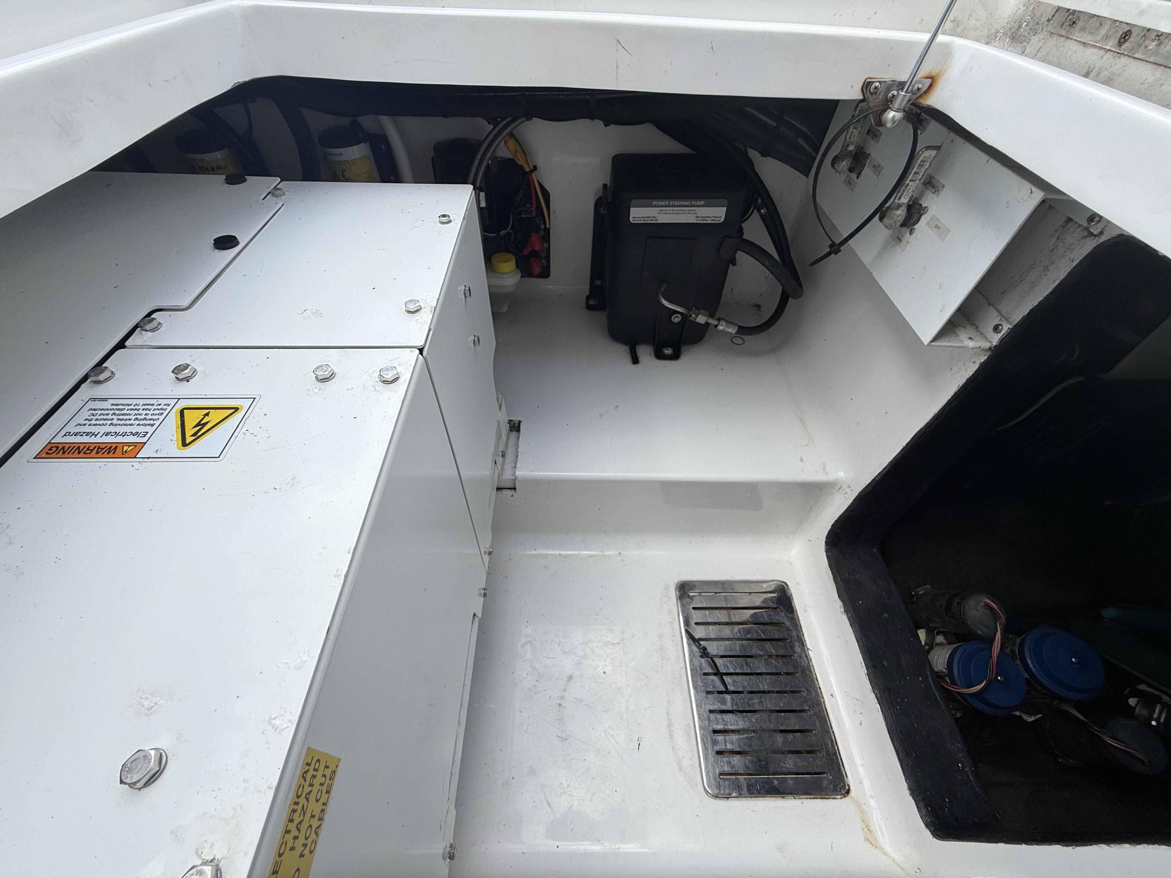 2024 Front Runner 39 CC boat engine compartment with electrical components and warning labels.