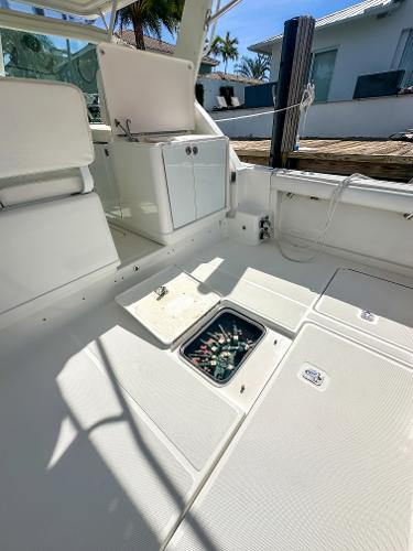 2006 Tiara Yachts 3200 Open interior with storage compartment, docked under sunny skies.