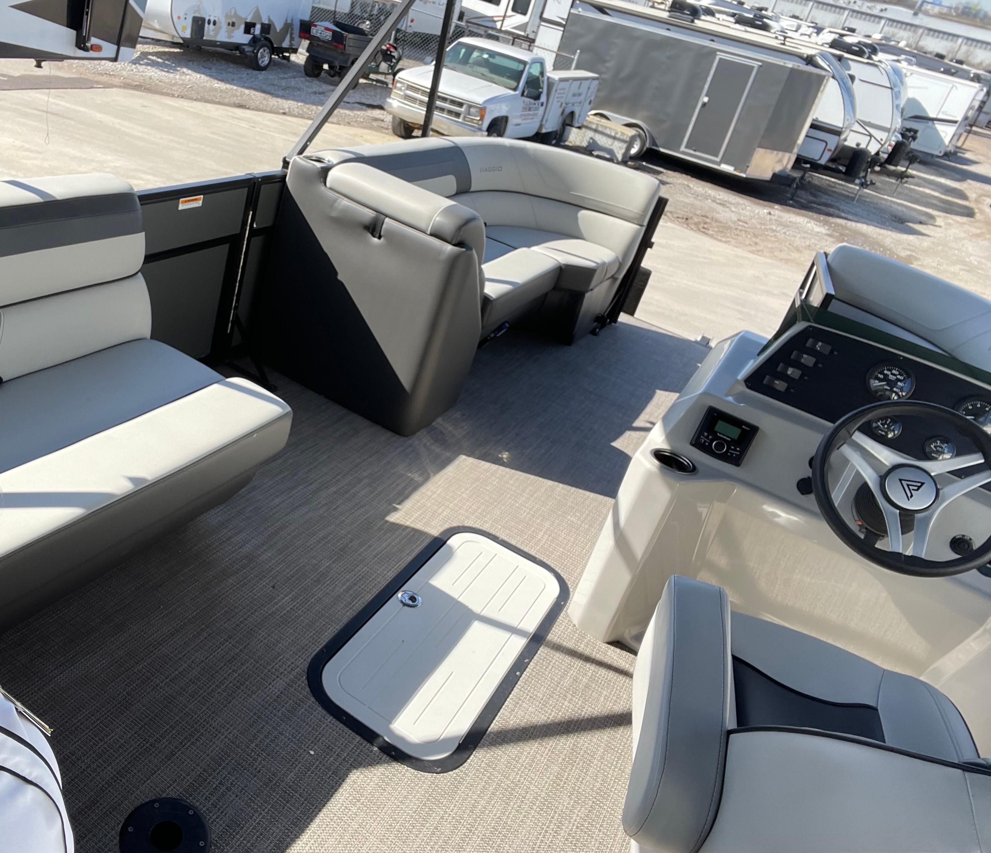 Interior of 2022 Viaggio Lago boat with modern seating and steering console.