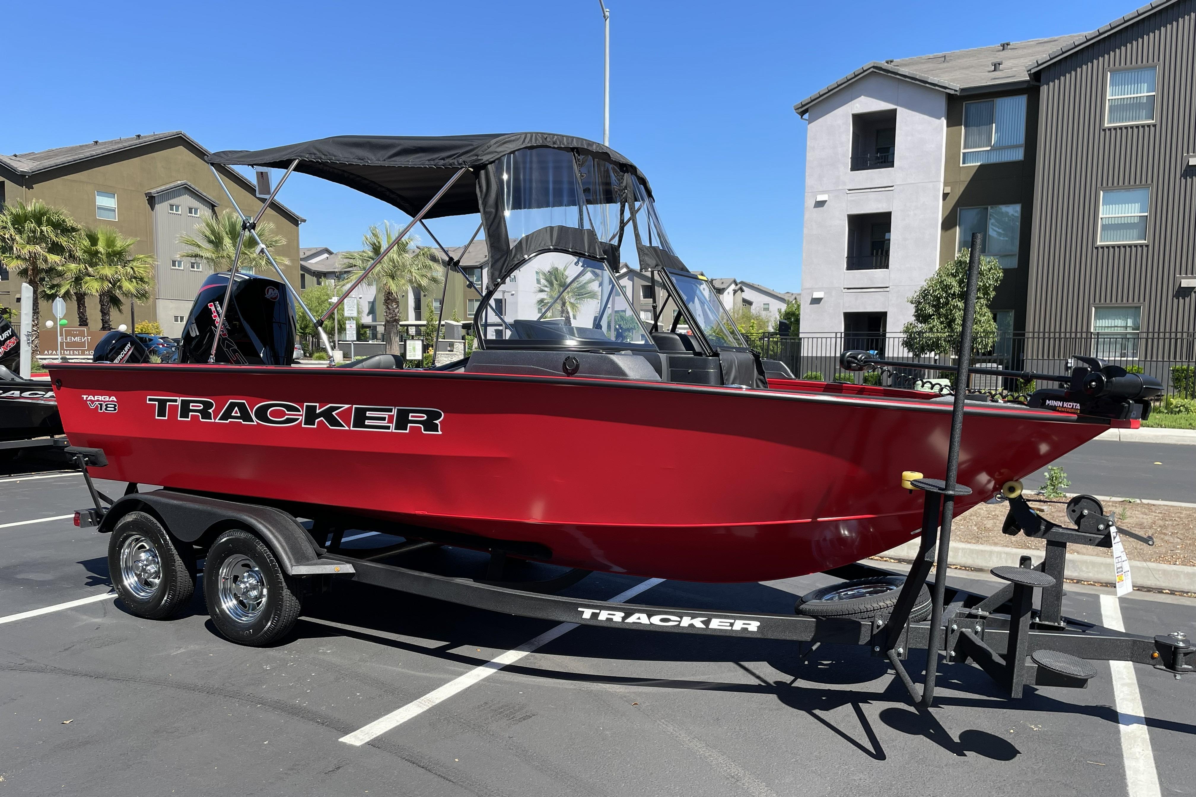 2026 Tracker Targa V-18 WT boat in parking lot, red exterior, on trailer.