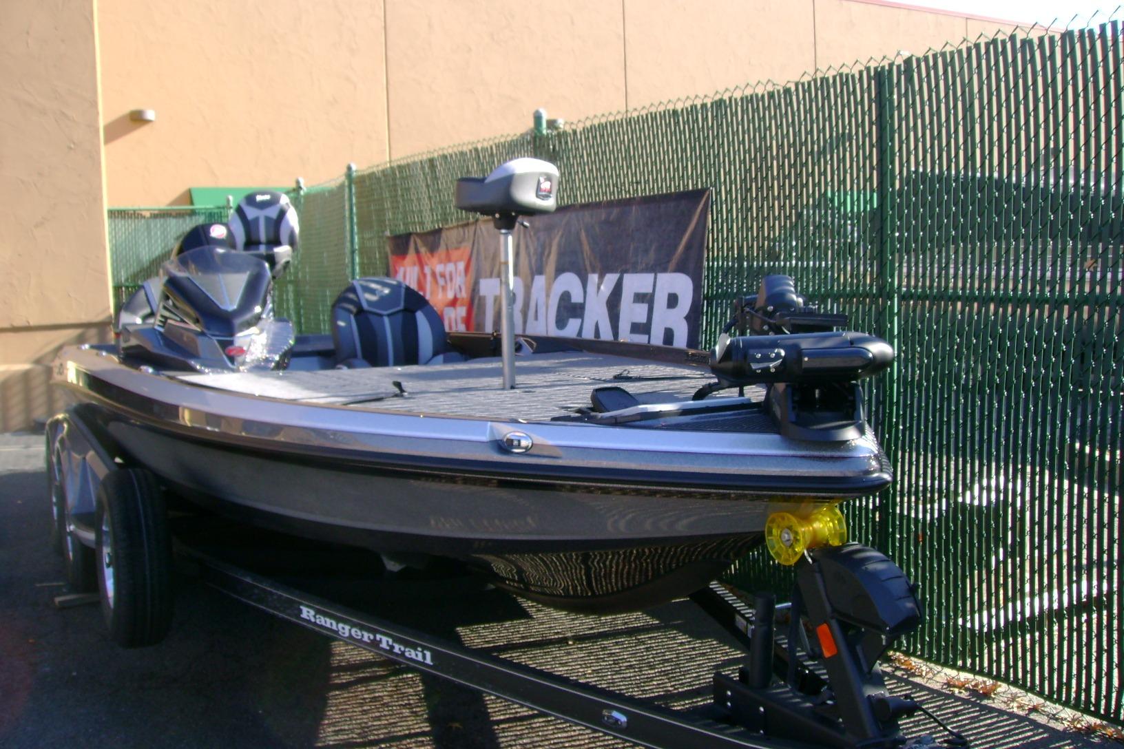 2025 Ranger Z520 boat on trailer, parked near a fence.