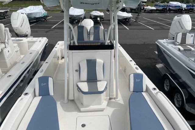 2025 Ranger 2360 Bay boat with blue and white seating, parked in a lot.