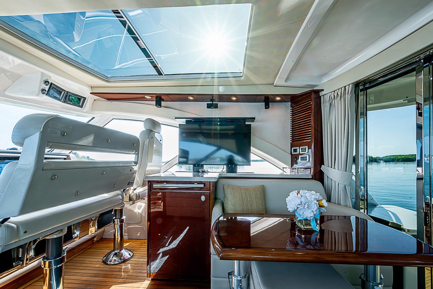 Luxurious interior of 2008 Sea Ray 60 Sundancer yacht with skylight and elegant seating.