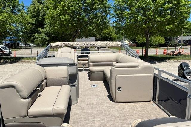 2025 Sun Tracker Fishin' Barge 22 DLX pontoon boat with spacious seating and canopy.