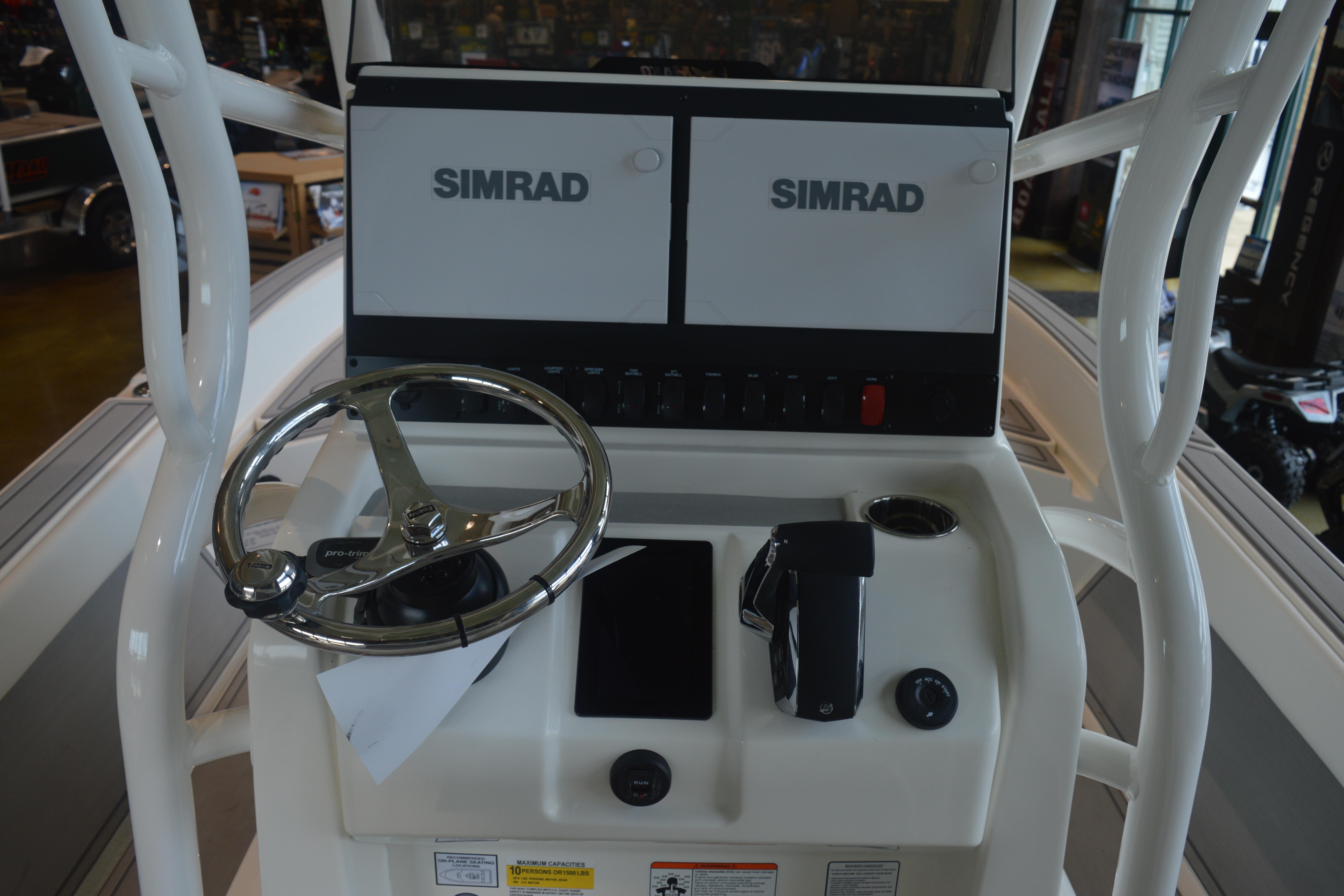 Steering console of 2026 Mako 24 APEX boat with Simrad displays.