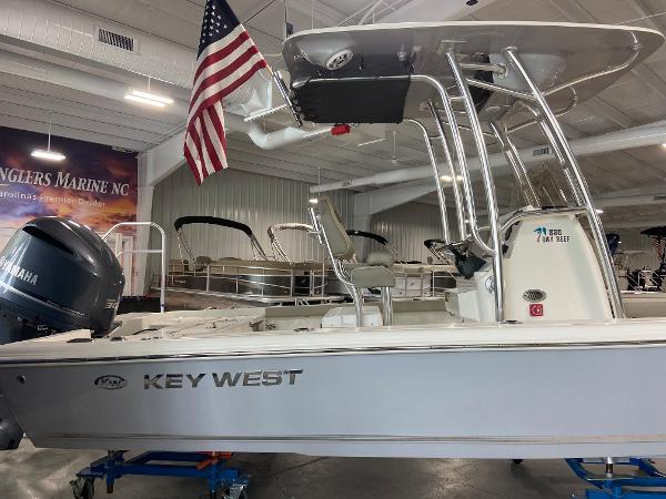 2024 Key West 250 Bay Reef boat displayed indoors with American flag.