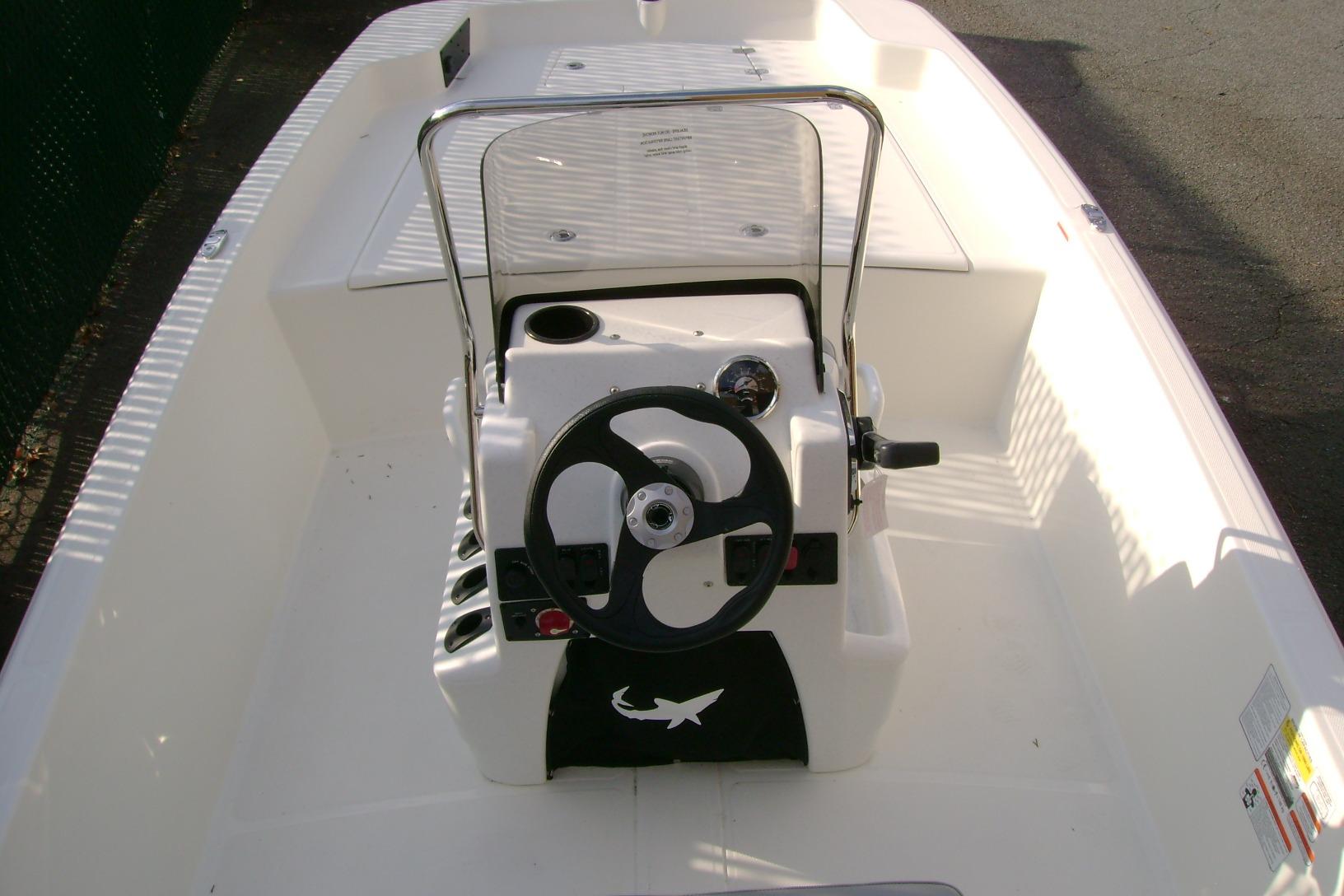 2026 Mako Pro Skiff 17 CC boat interior with steering console and seating area.