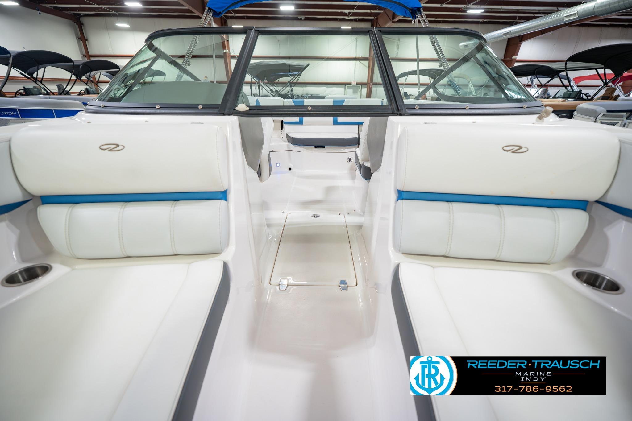 2015 Regal 2000 ESX Bowrider interior with white and blue seating in showroom.