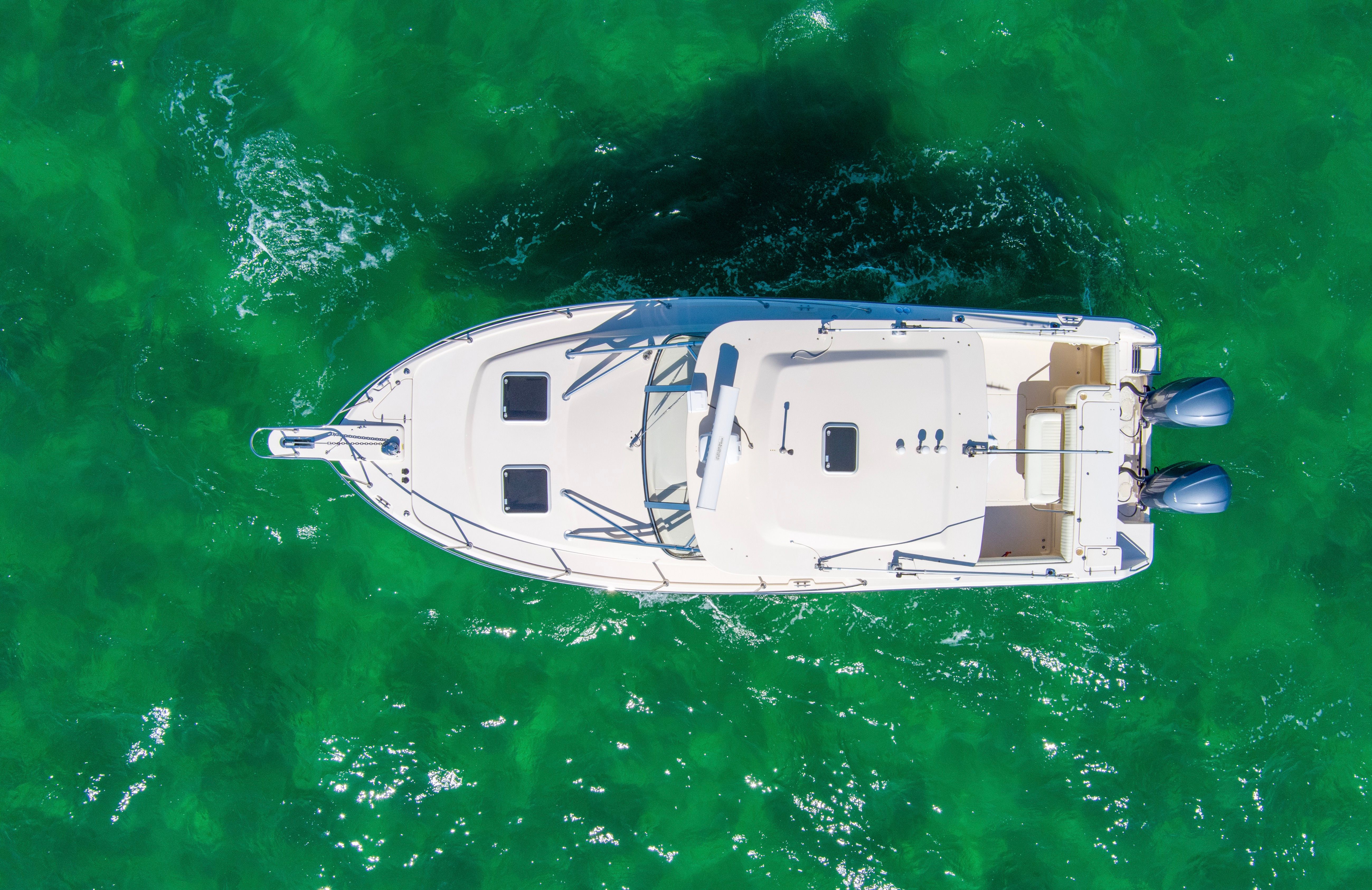 Aerial view of 2009 Grady-White Express 330 on green water.