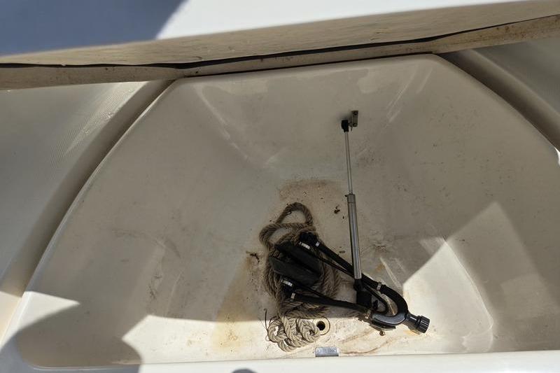 Storage compartment of 2004 Aquasport 215 Osprey Sport with rope and equipment.