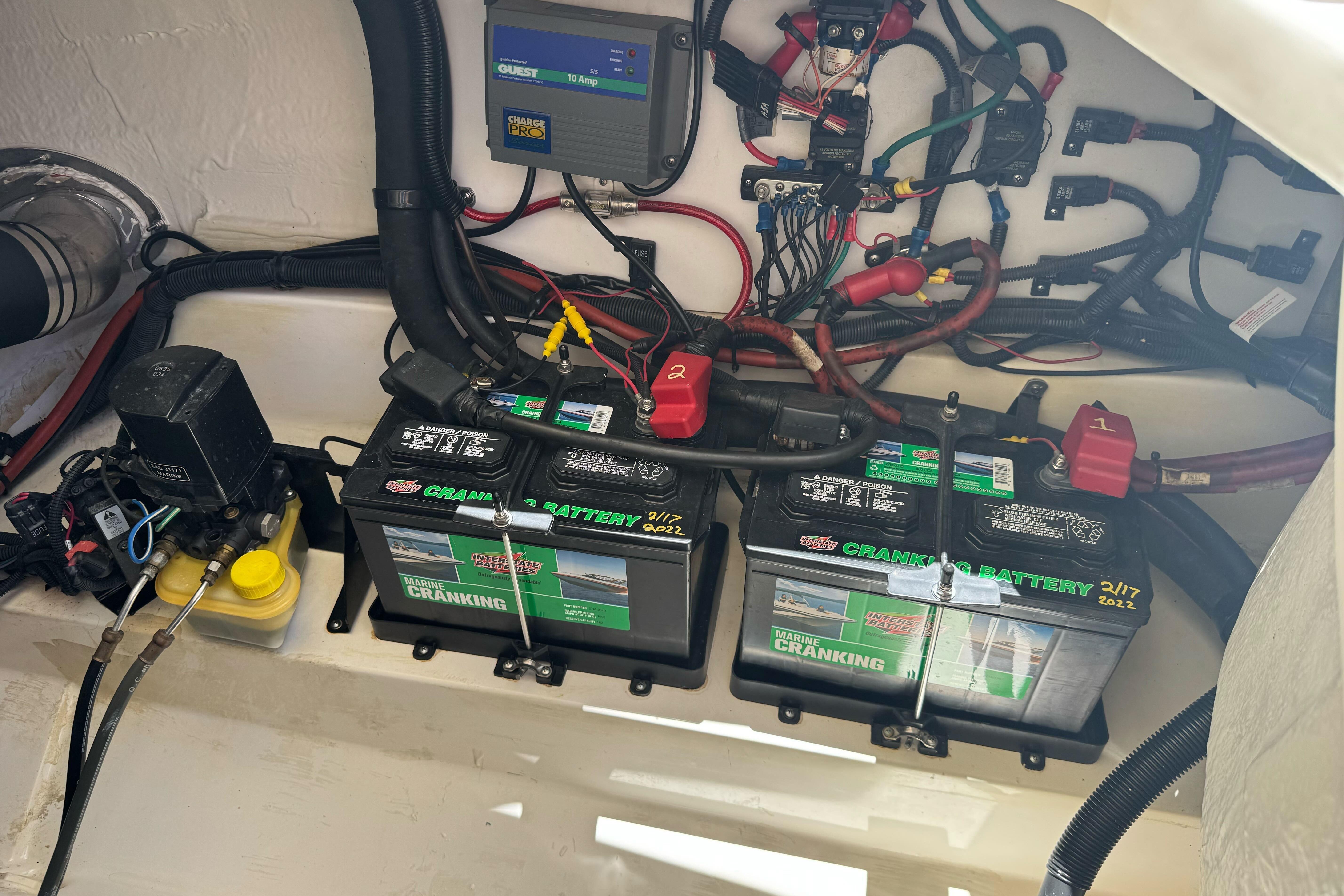 Engine compartment of a 2007 Sea Ray SLX 250 with marine batteries and wiring.