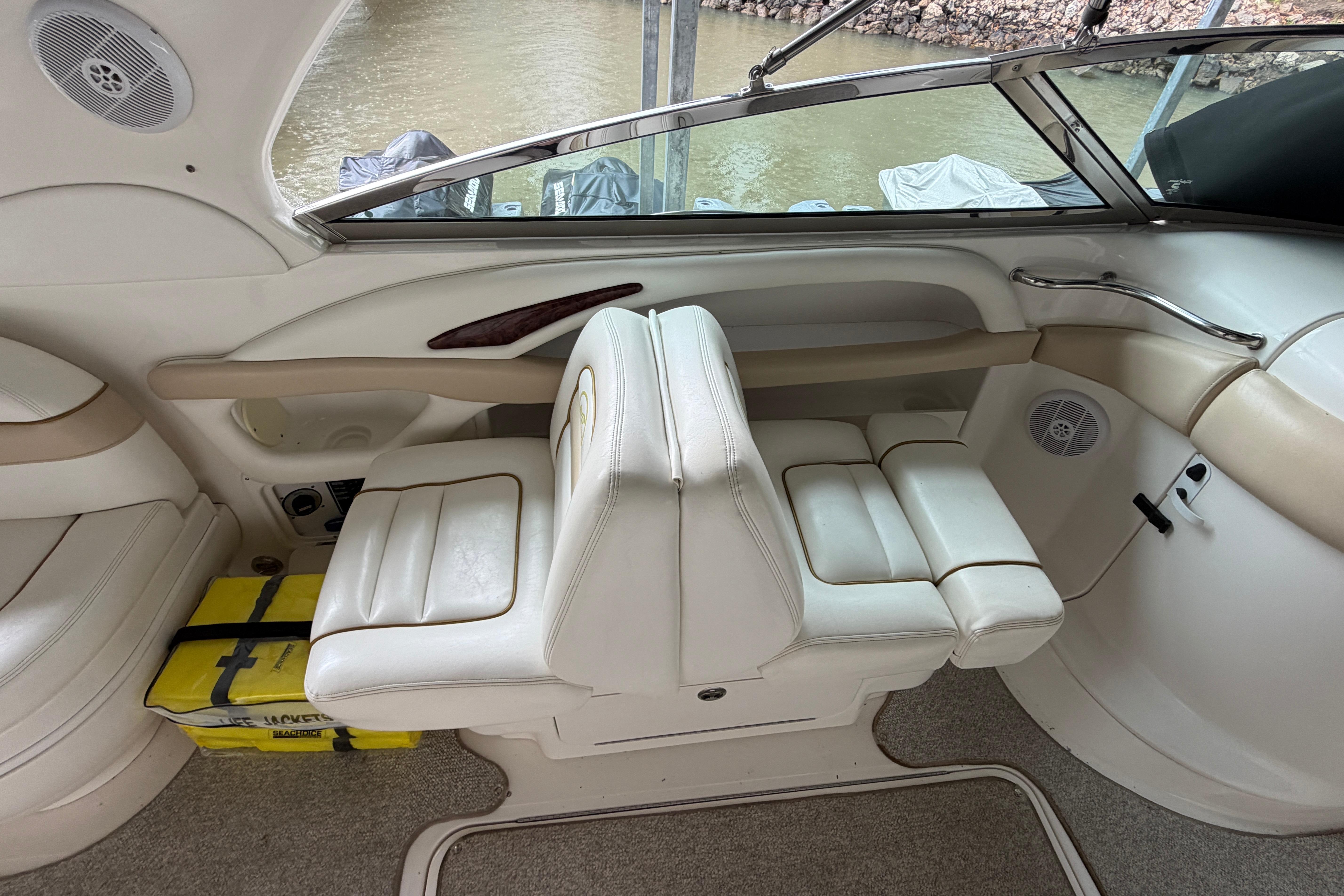 Interior of a 2003 Sea Ray 290 Bowrider boat with white seating and beige accents.