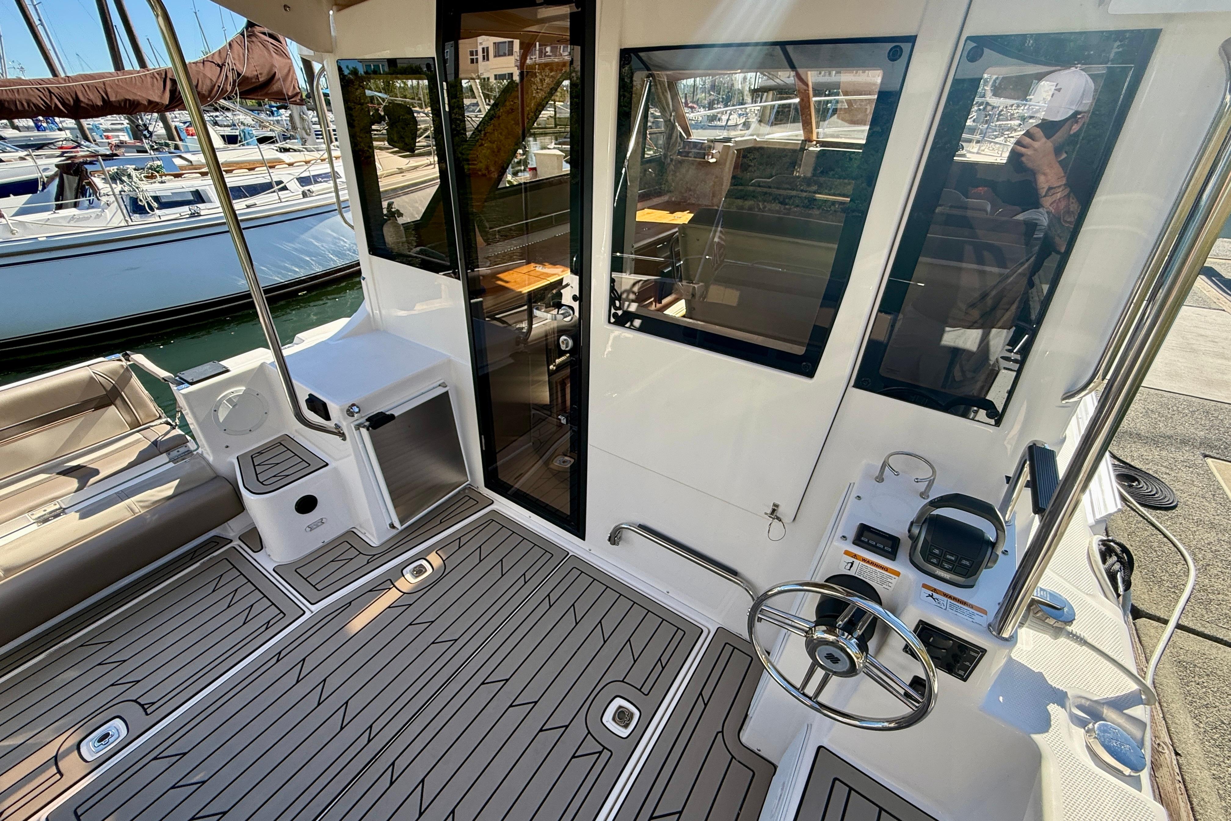 2023 Cutwater C-30 Sedan boat interior with modern helm and seating area at marina.