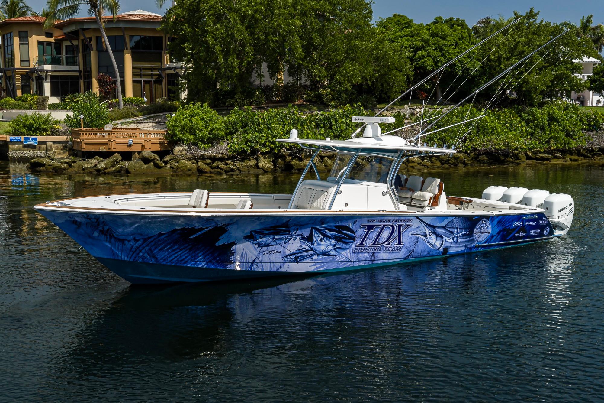 2020 Valhalla Boatworks V-41 with custom graphics, docked near luxury waterfront homes.