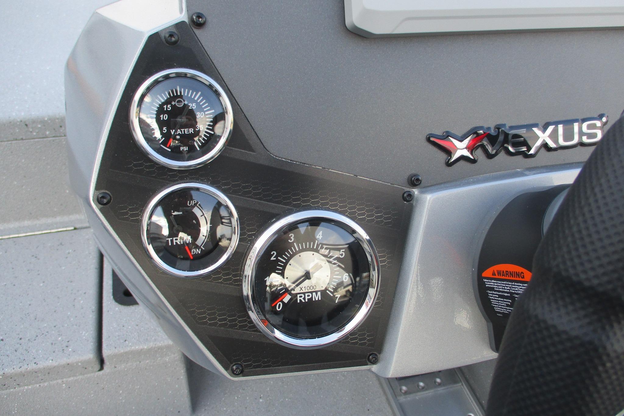 Dashboard of 2026 Vexus AVX2080 boat with gauges and logo.