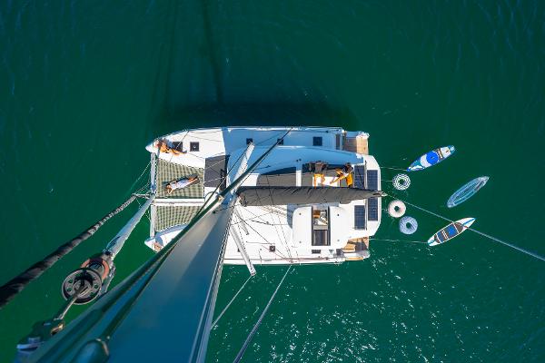Aerial view of Lagoon 43 catamaran, 2025 model, with paddleboards and inflatables in the water.