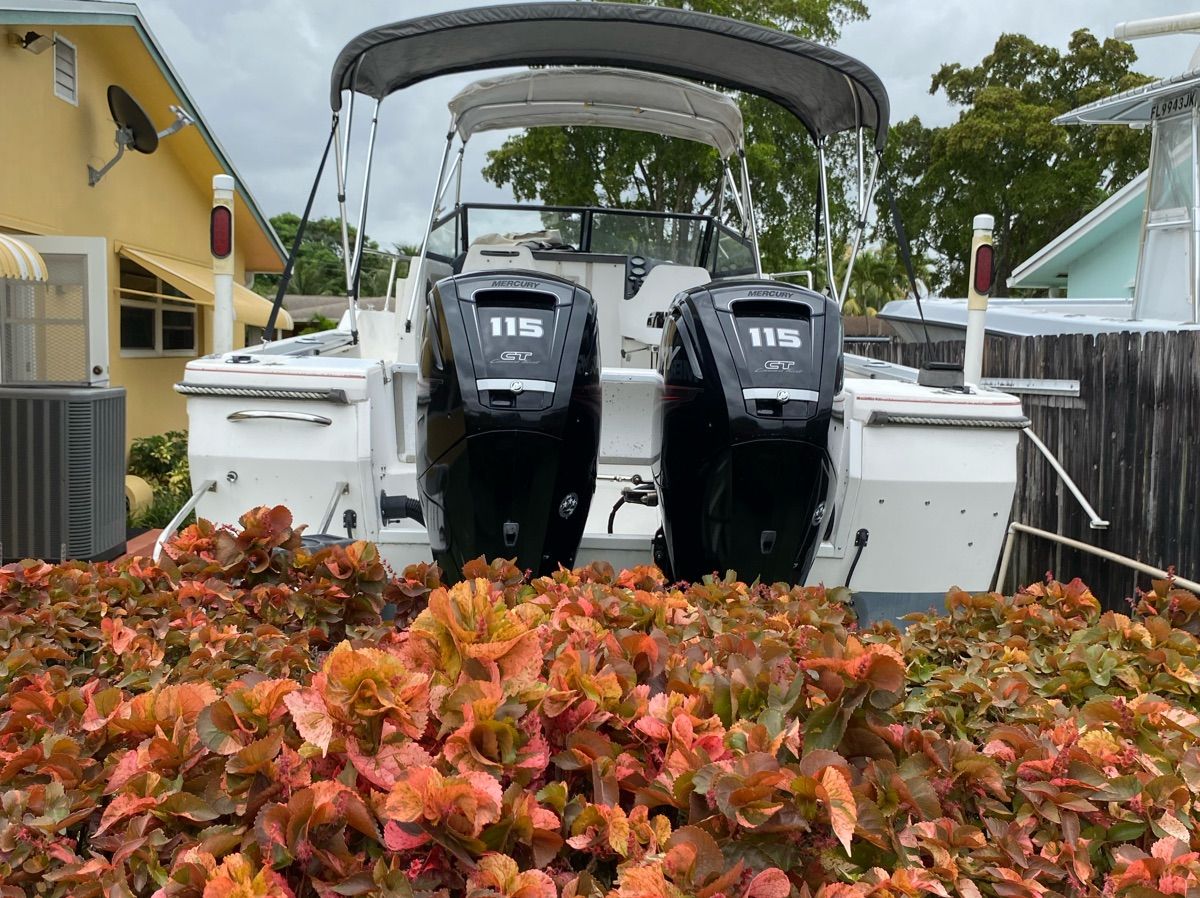 1990 Bayliner 2302 Trophy boat with dual outboard motors.
