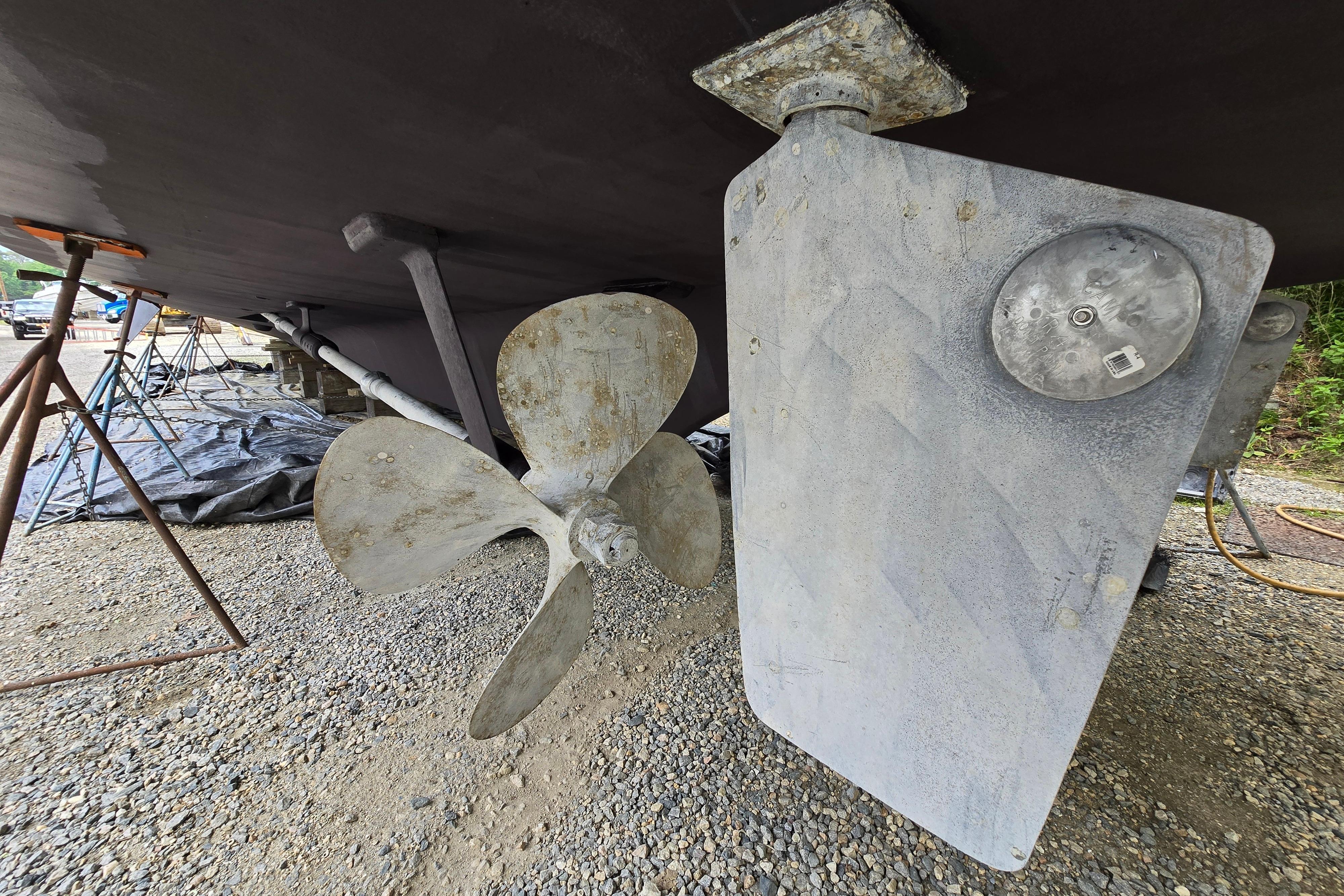 Propeller and rudder of a 1980 Hatteras 70 Motor Yacht on dry dock.