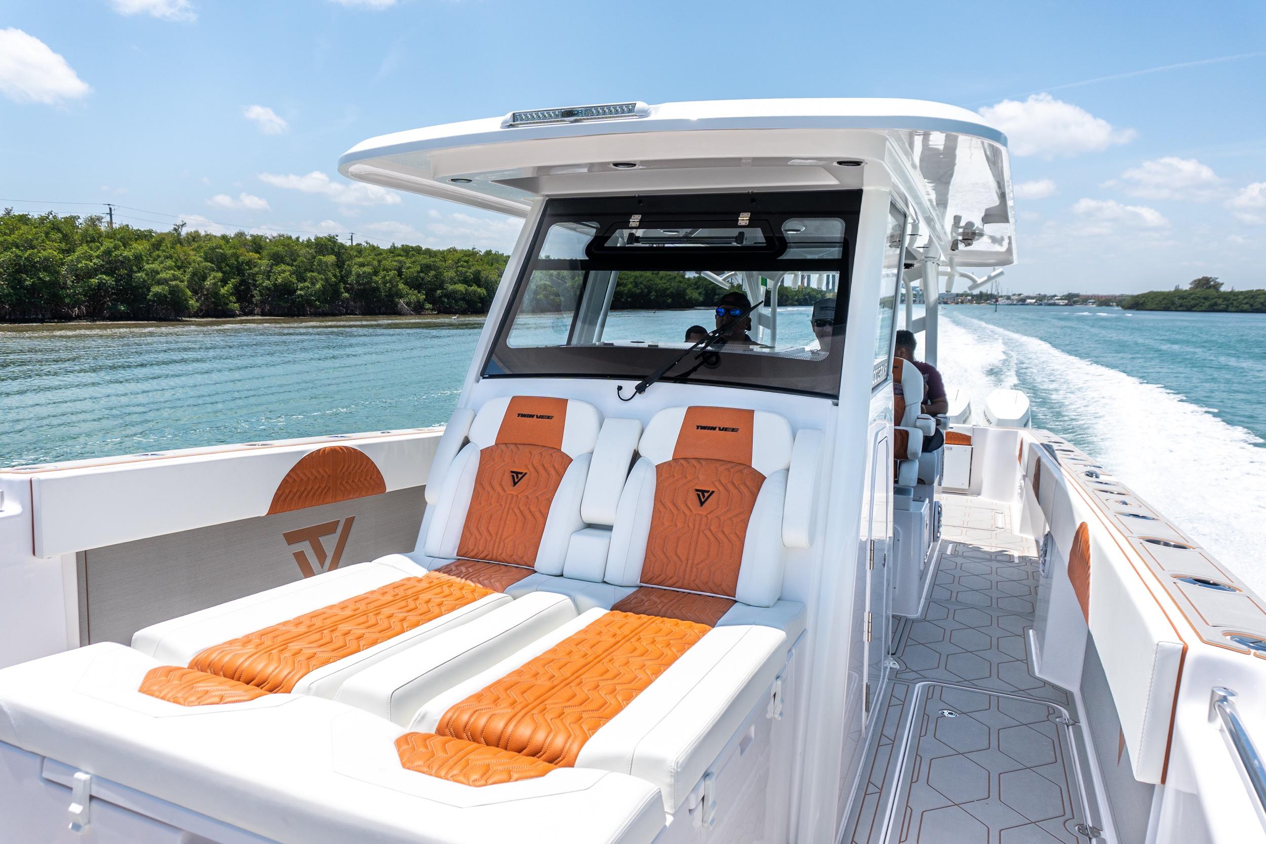 2026 Twin Vee 400 GFX2 CC boat cruising on a sunny day, featuring luxurious seating.