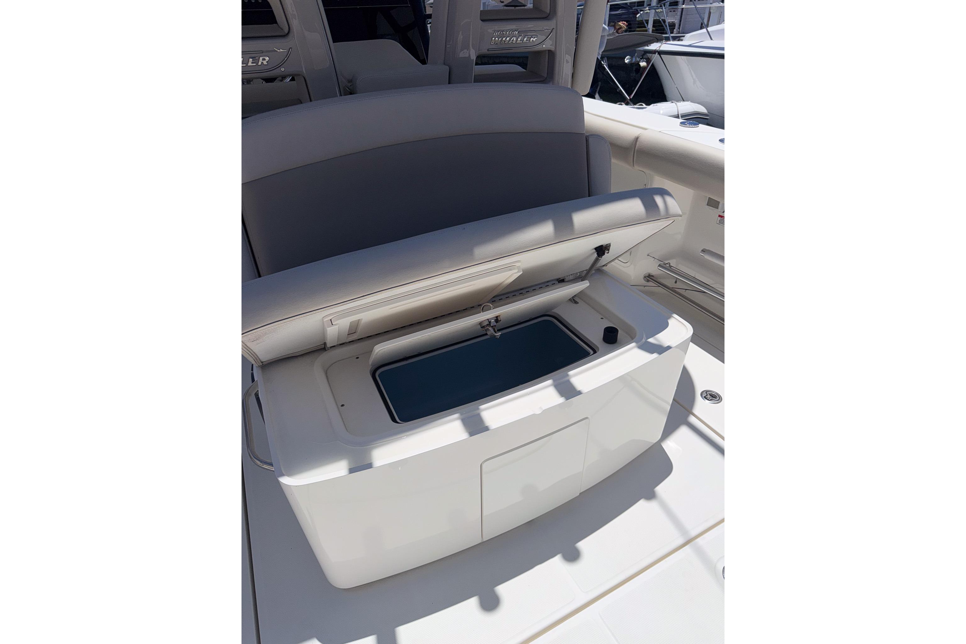 2021 Boston Whaler 330 Outrage boat interior with open storage compartment.