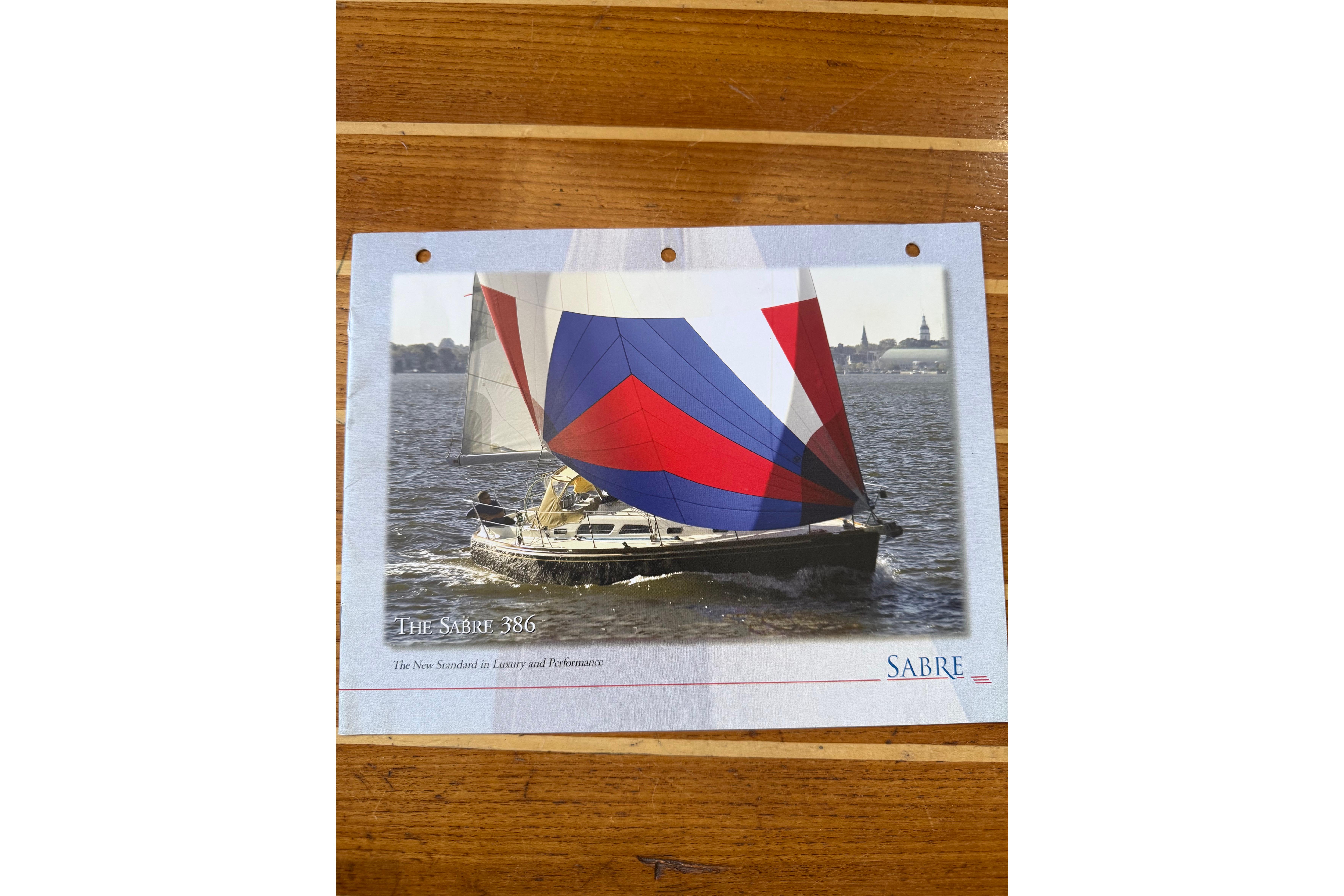 Sailing yacht Sabre 386, 2004 model, with colorful sails on open water.