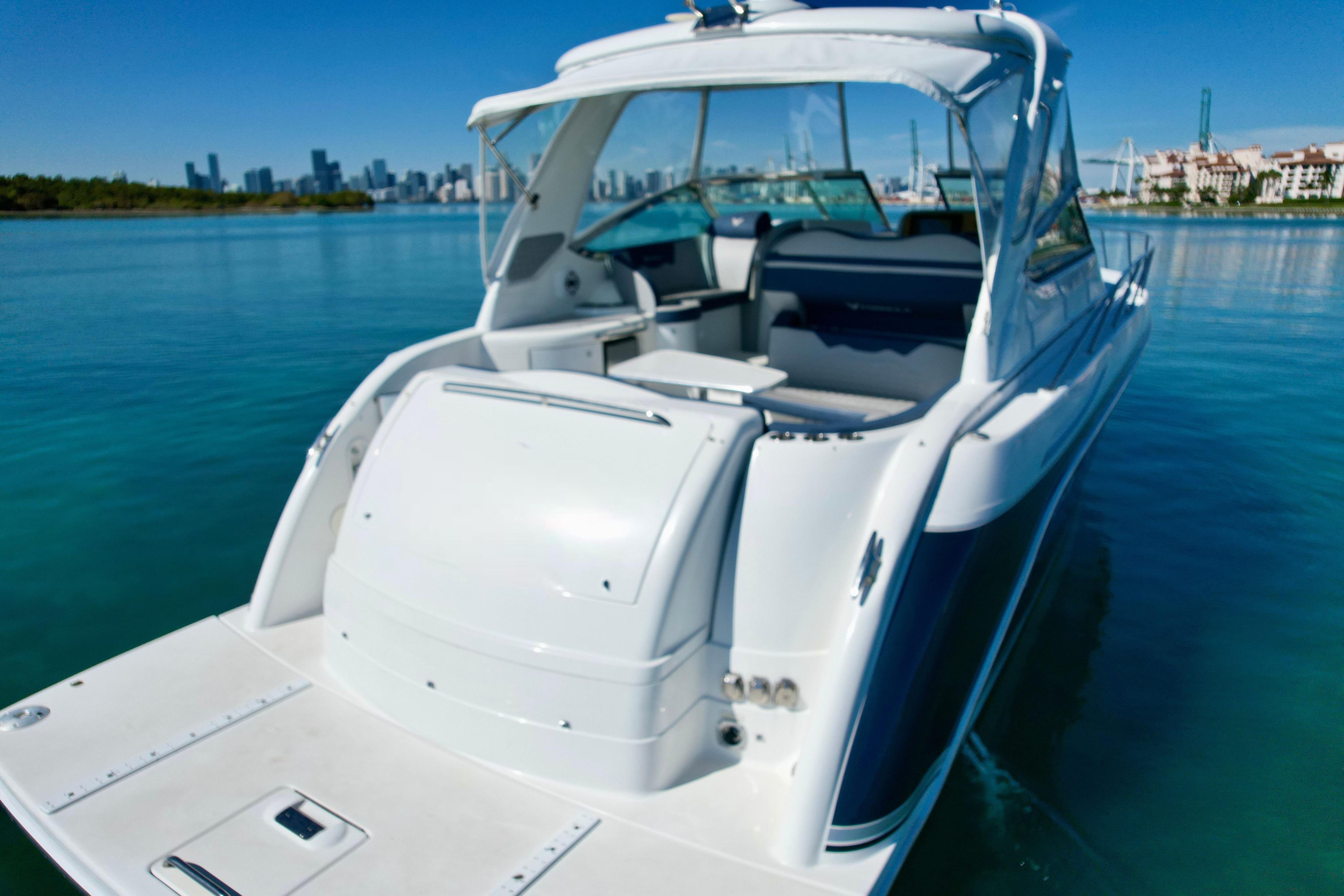 2006 Formula 40 Performance Cruiser on calm water with city skyline in background.