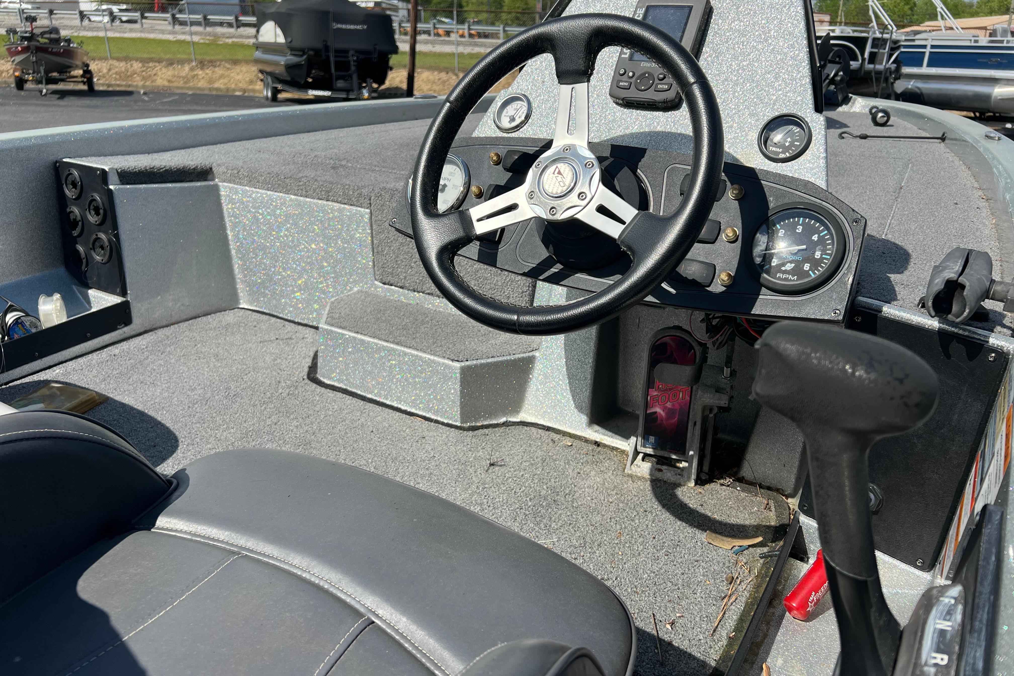 Interior of a 2015 Stratos 186 VLO boat with steering wheel and dashboard controls.