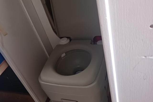 Compact marine toilet in 1989 O'Day 272 sailboat bathroom.