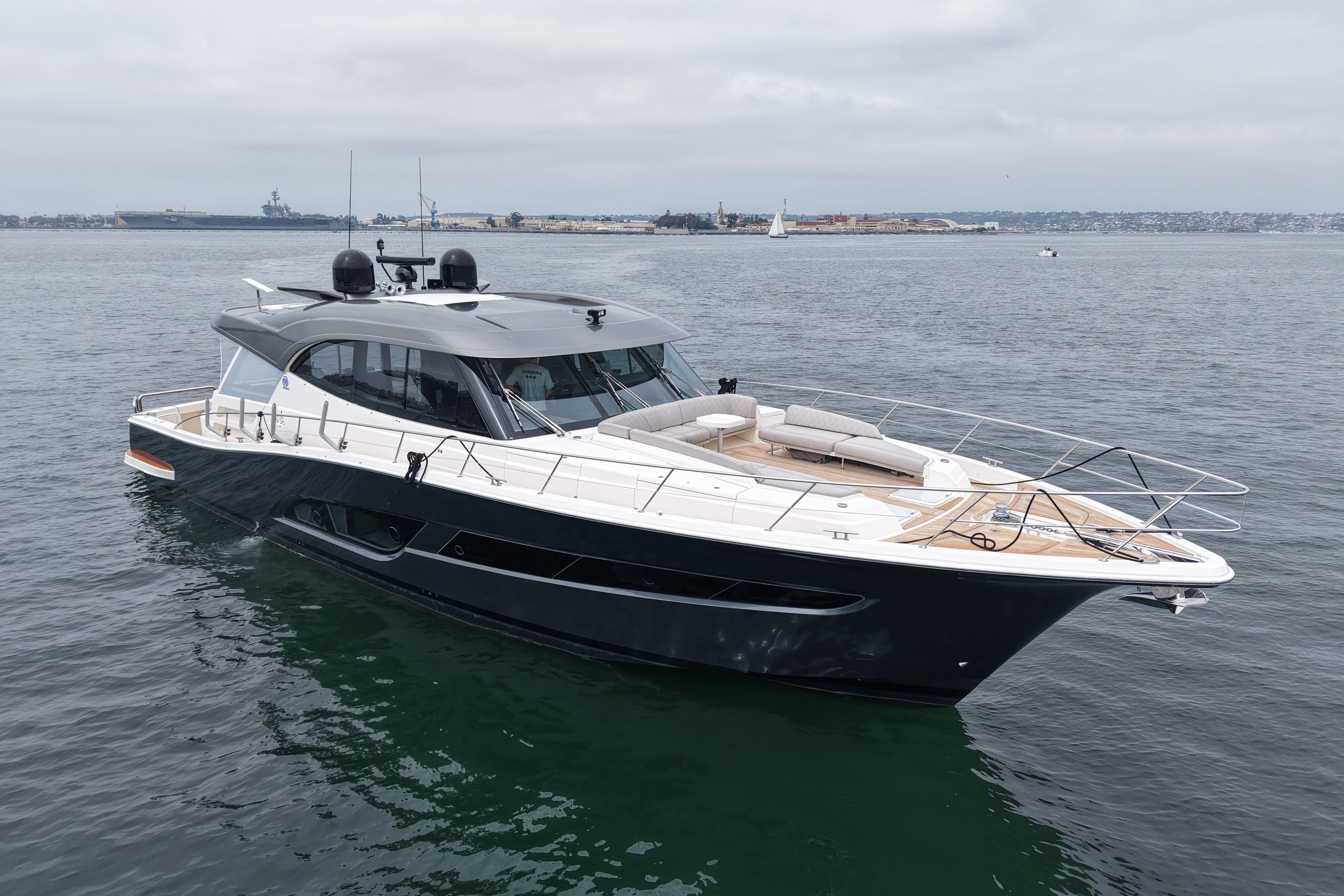 2023 Riviera 645 SUV luxury yacht on calm waters, showcasing sleek design and spacious deck.