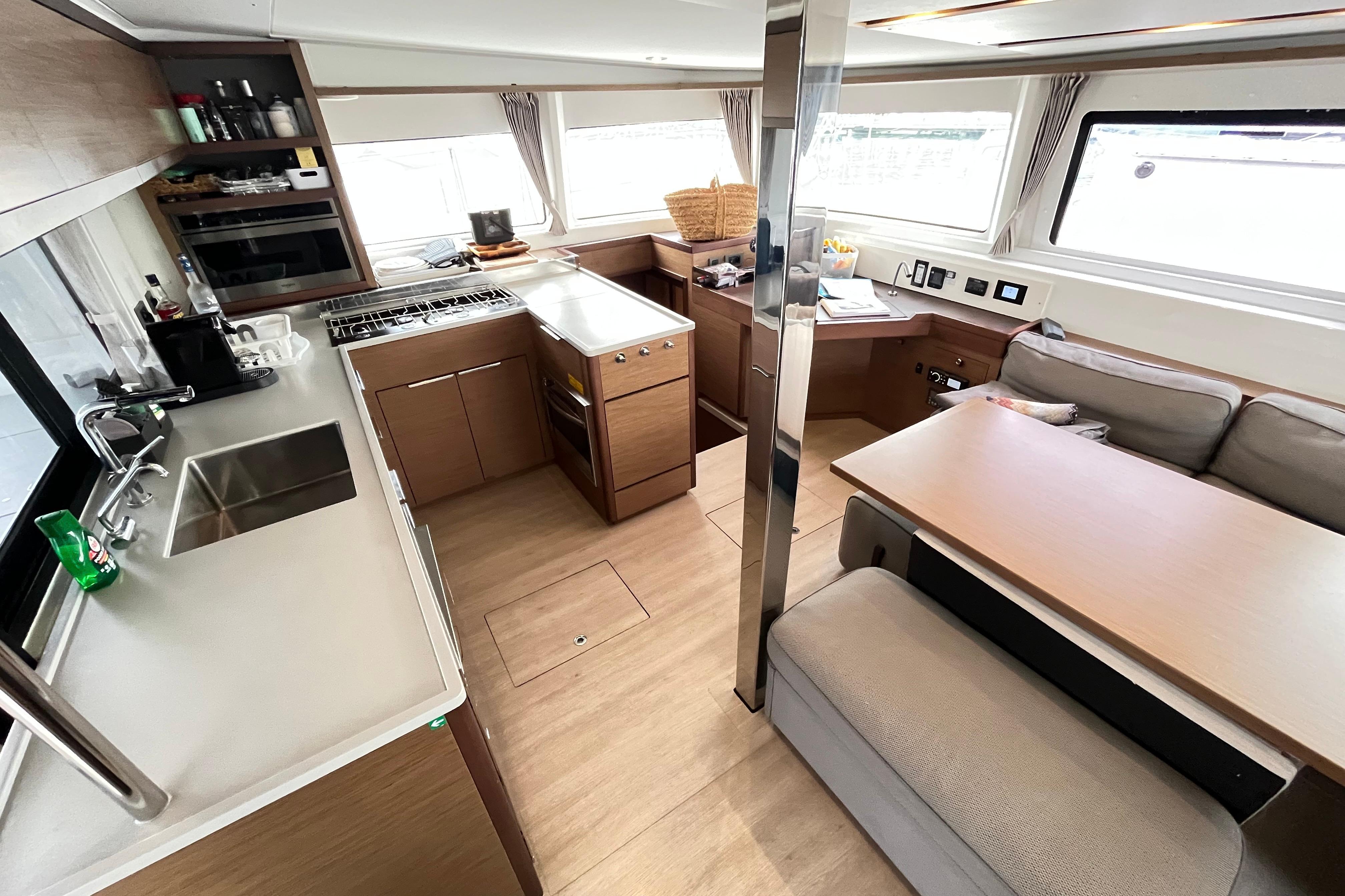 Modern interior of 2020 Lagoon 46 catamaran featuring kitchen and dining area.