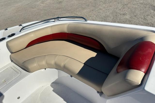 2016 Hurricane SunDeck Sport 188 OB boat with beige and red cushioned seating.